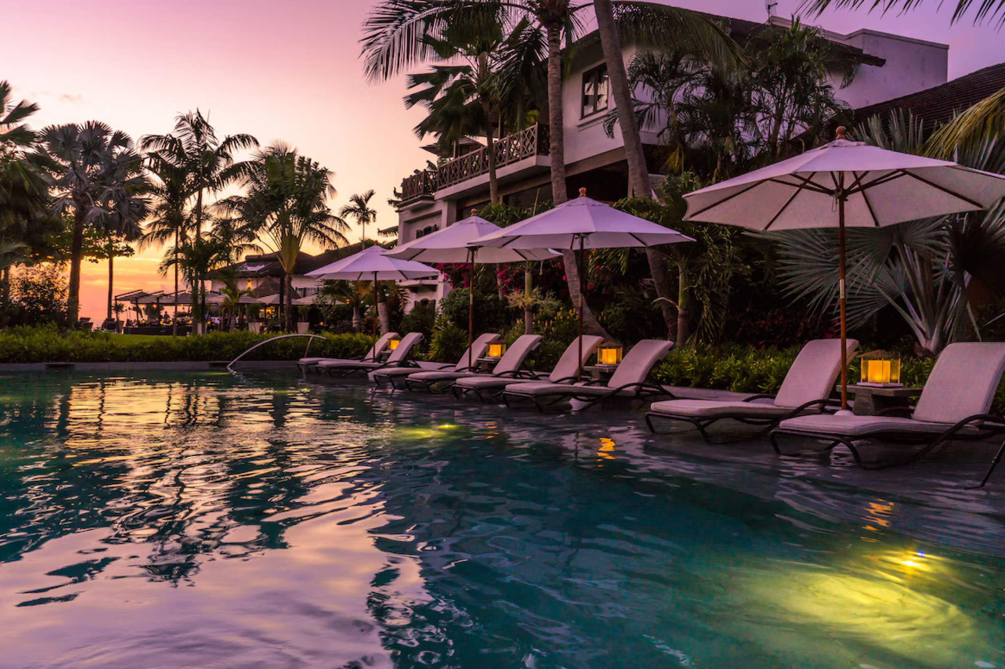 Sunset pool view at The Sandpiper, a boutique Caribbean escape surrounded by lush gardens, recognized among the best luxury resorts in Barbados.