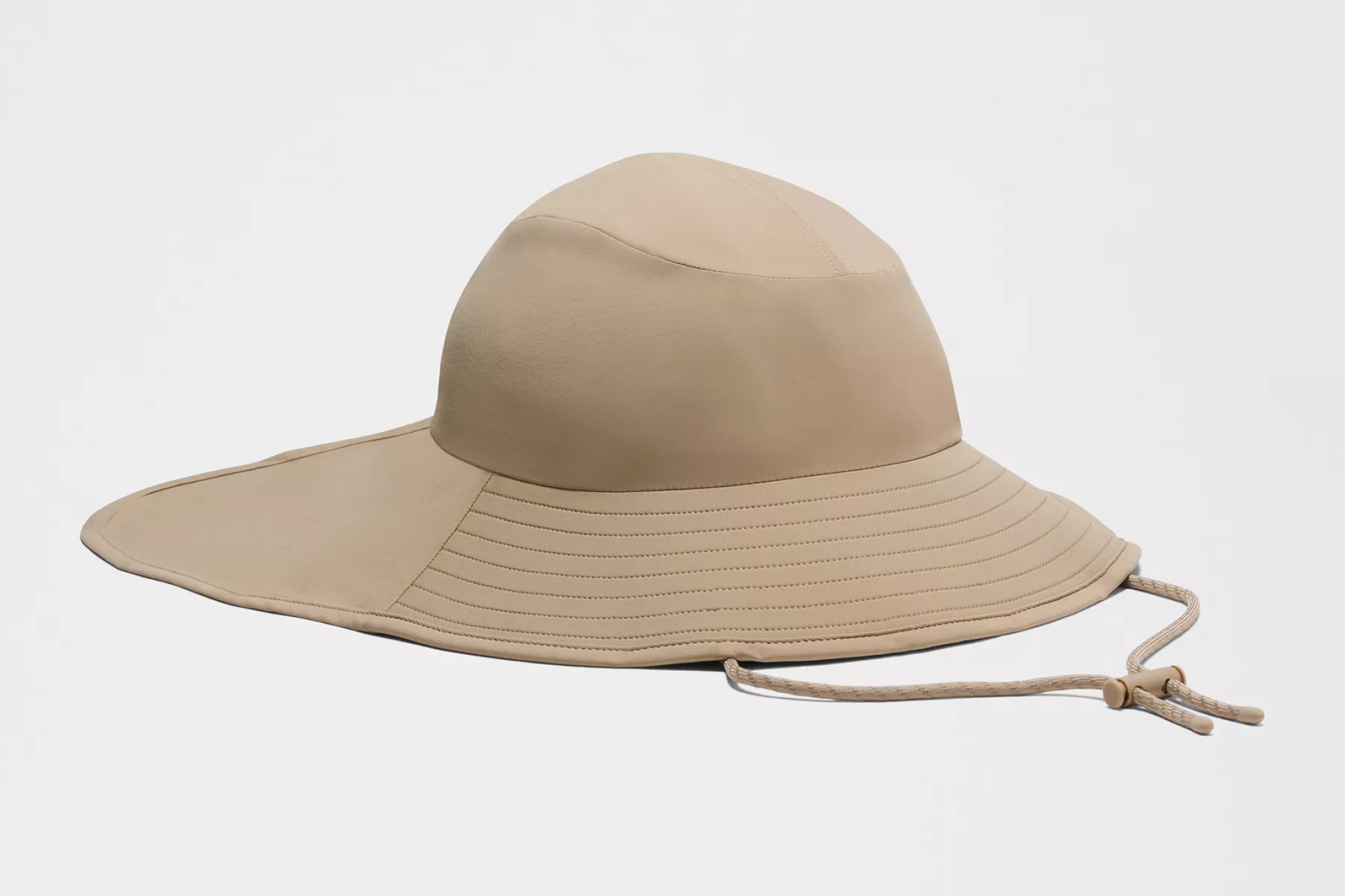 lululemon All Sport Wide-Brim Hat in beige with long curved brim and adjustable cord, highlighted among the best sun hats in 2025 for active coastal wear and all-day shade.
