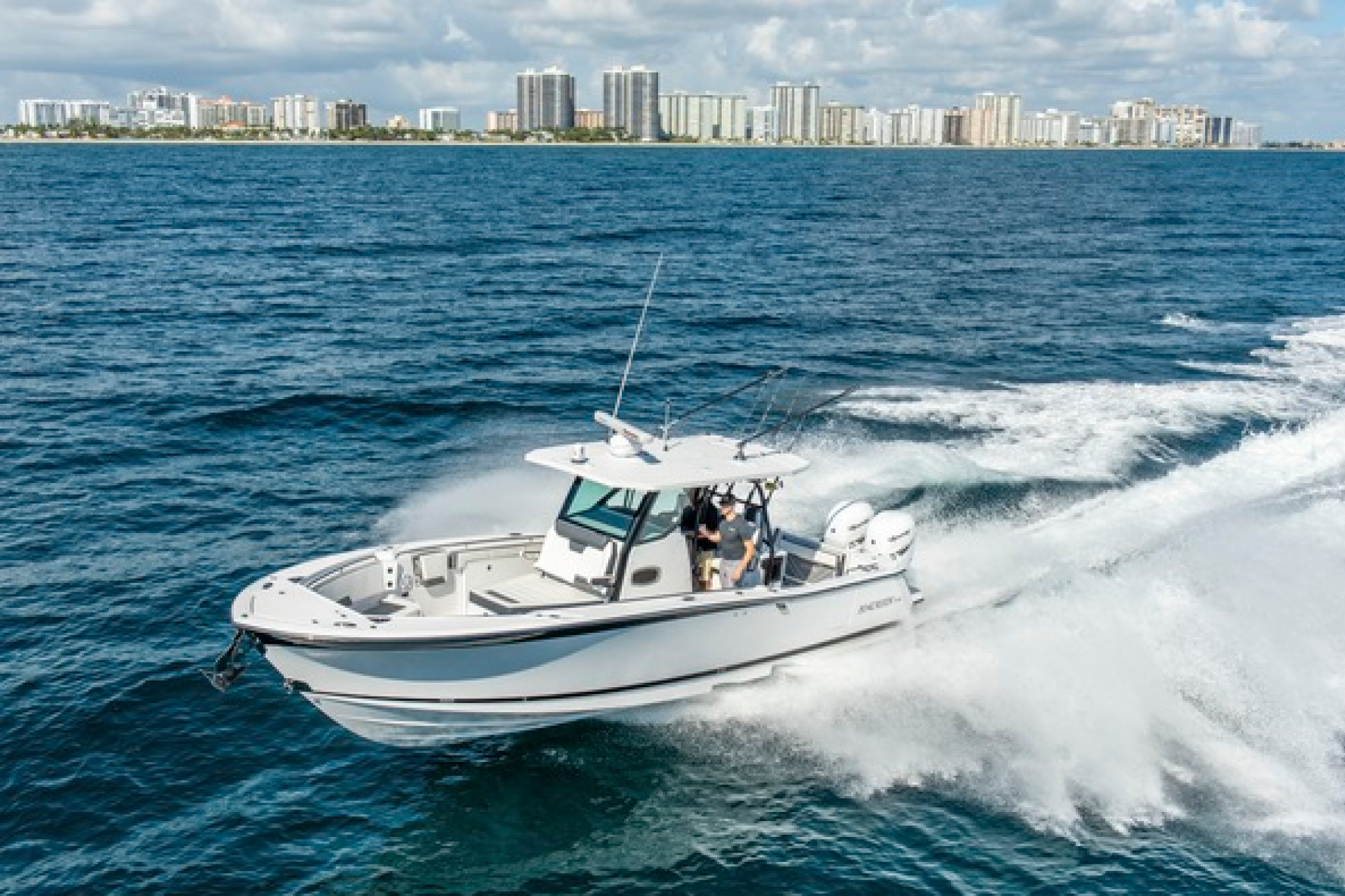 Aerial view of the Blackfin 332CC running offshore with twin outboards and wide beam.