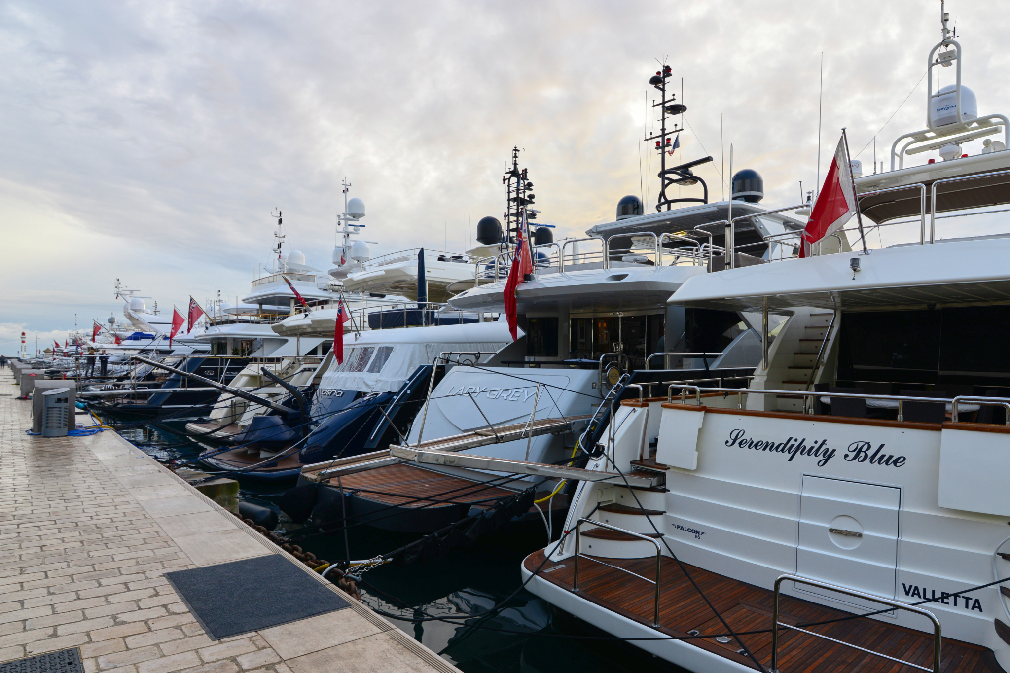 A line of superyachts moored along the quay at Vieux Port during the Cannes Yachting Festival 2025, just before sunset.