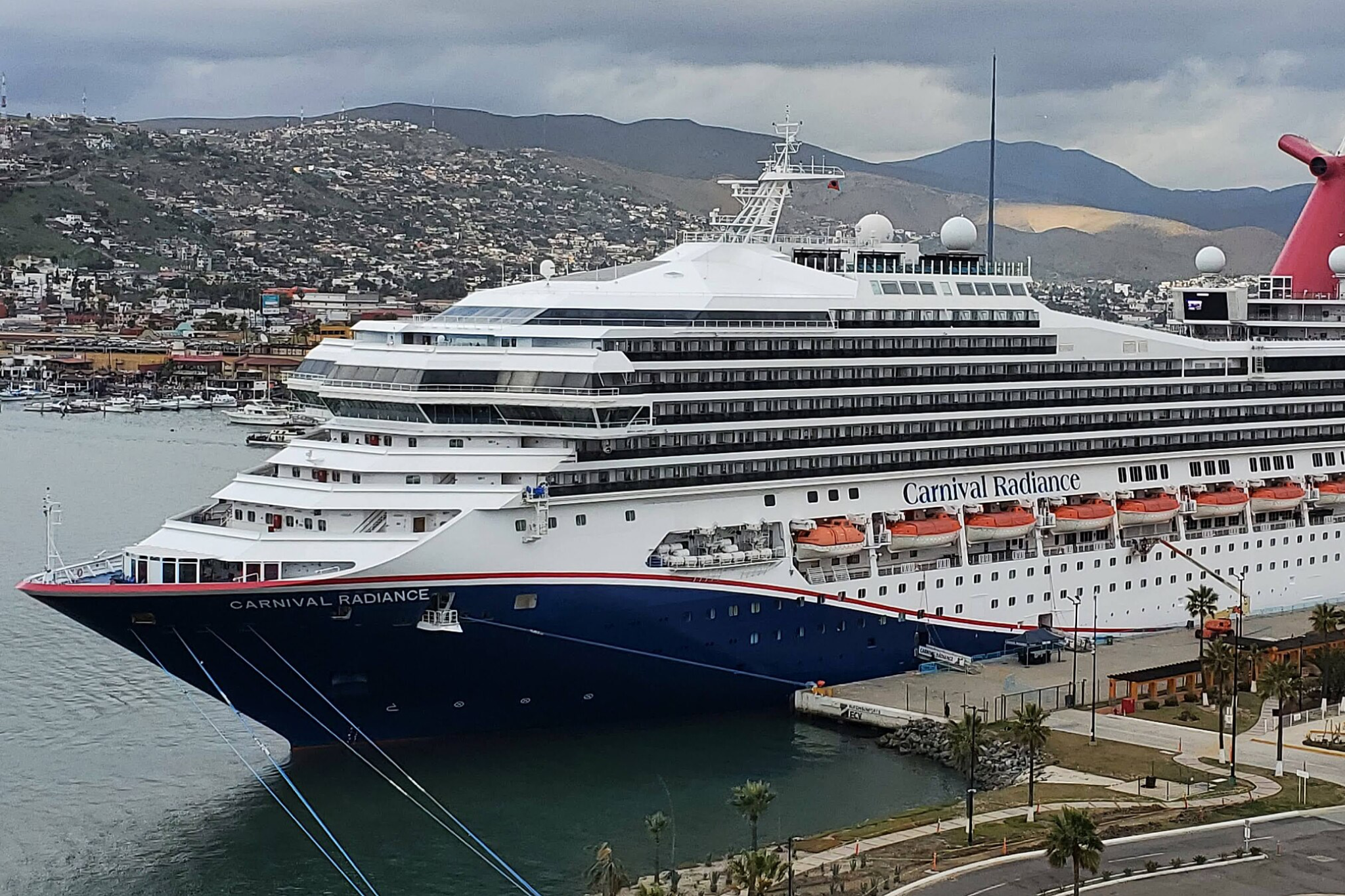 Carnival Cruise Lines Ships by Size visual of Carnival Radiance underway, showing its refreshed exterior, stacked balcony cabins, and activity-focused upper decks