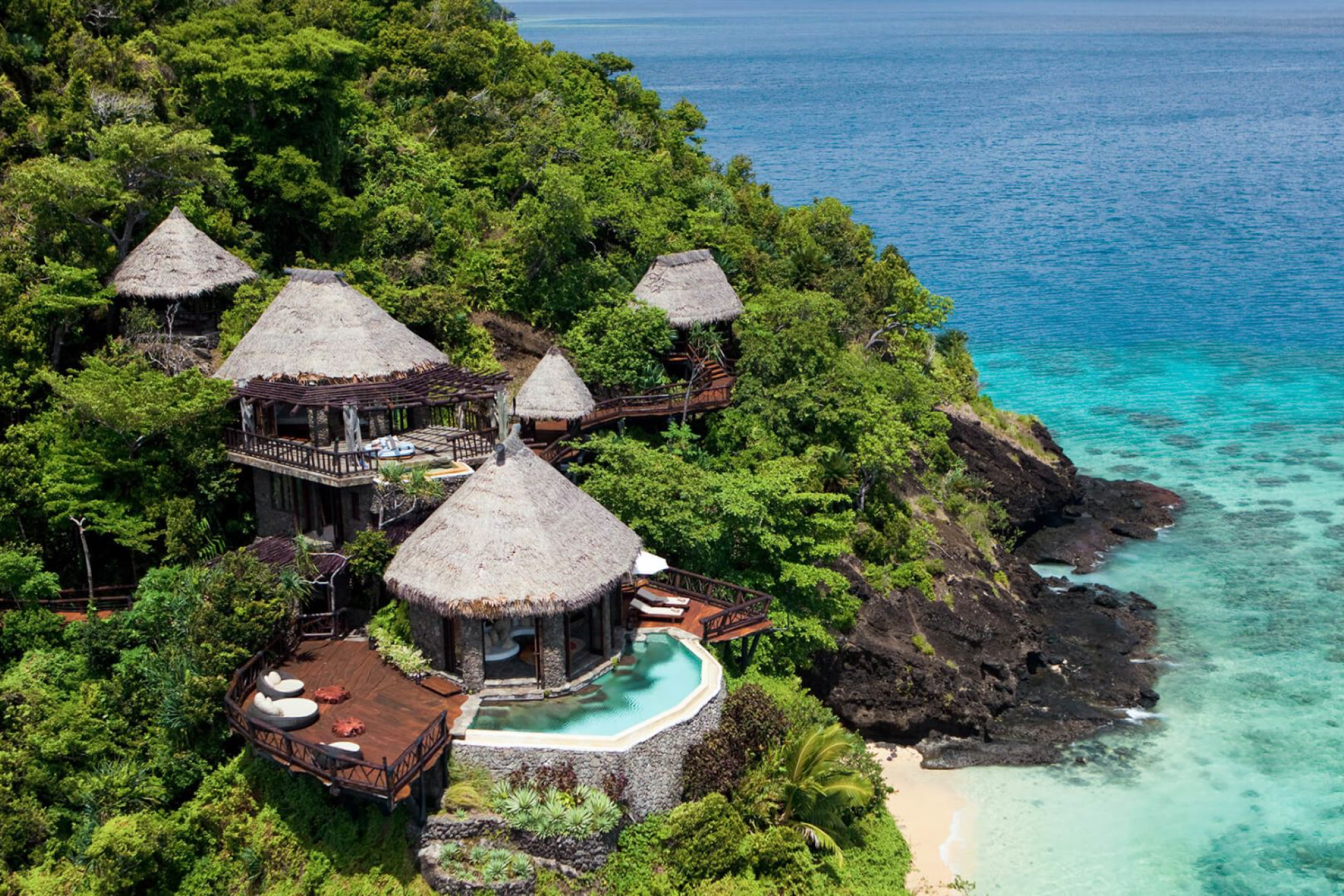 Multi-level cliffside villas at COMO Laucala Island, each with private plunge pools and expansive oceanfront decks.