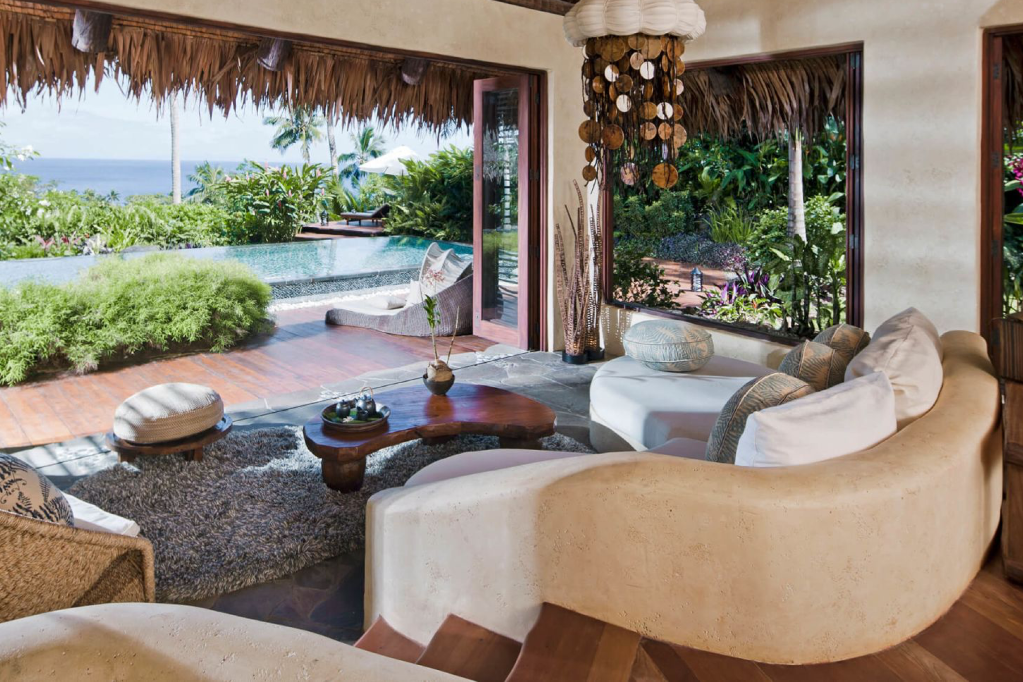 Open-concept living room at COMO Laucala Island villa, blending indoor-outdoor design with panoramic ocean views.