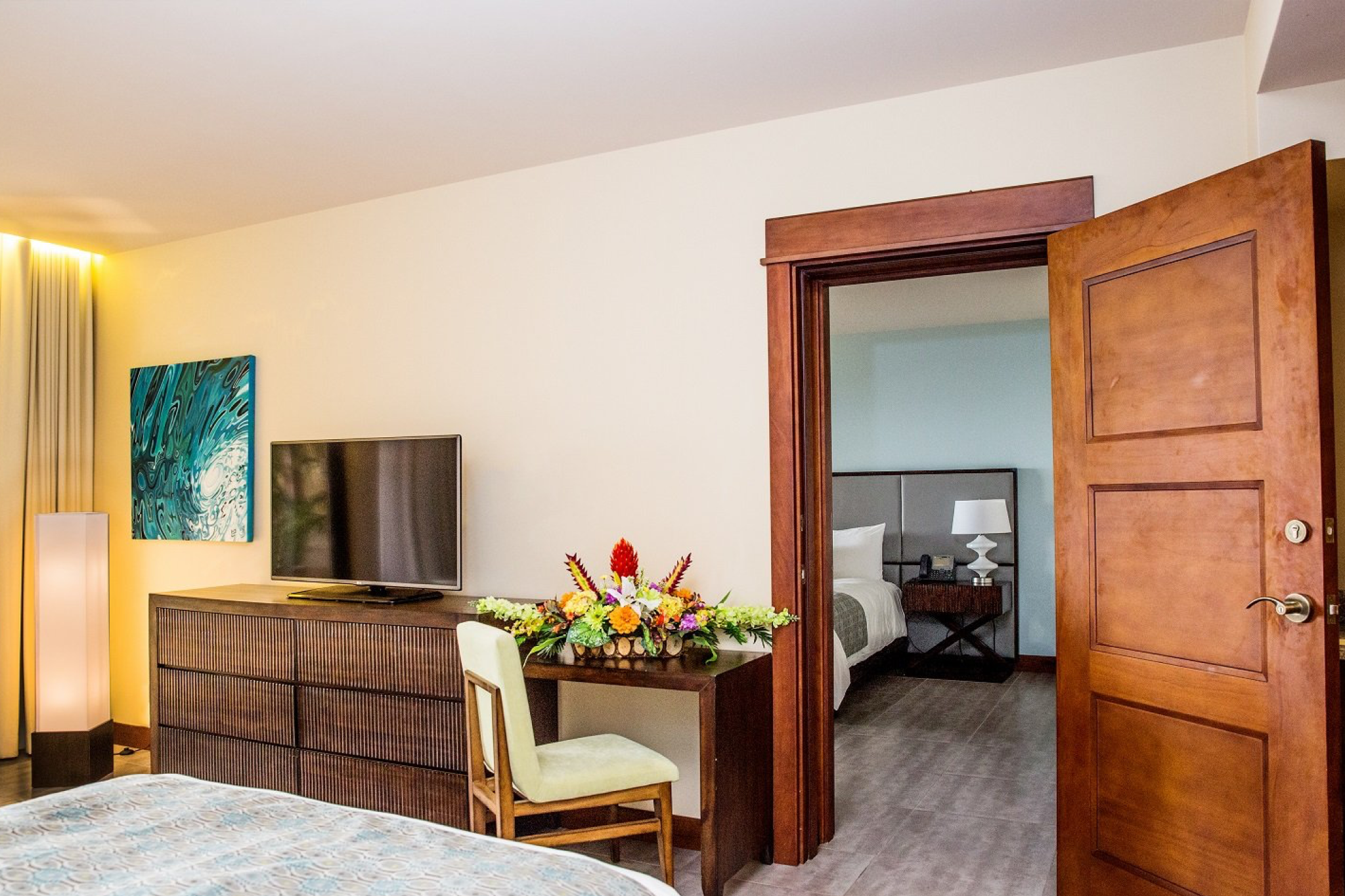 Spacious connecting suite at Crocs Resort & Casino with modern décor, flat-screen TV, and two separate sleeping areas.