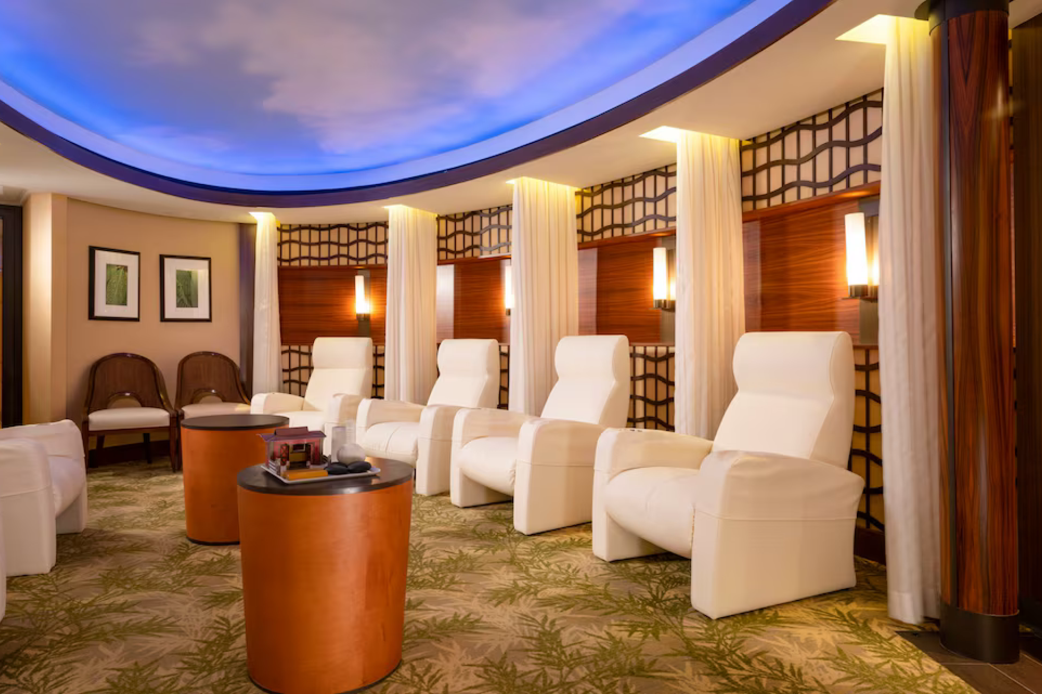 Spa lounge aboard Disney Destiny offering serene recliners, warm wood details, and a softly lit ceiling designed for relaxation.