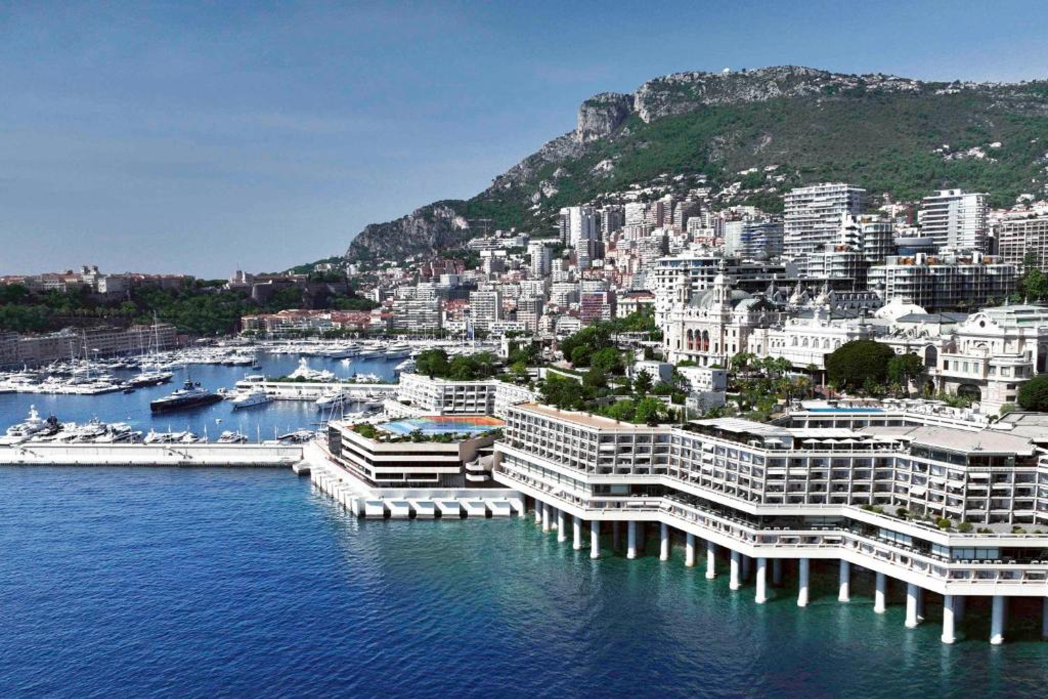 Aerial view of Fairmont Monte Carlo overlooking the Mediterranean and Monaco’s yacht-filled harbor