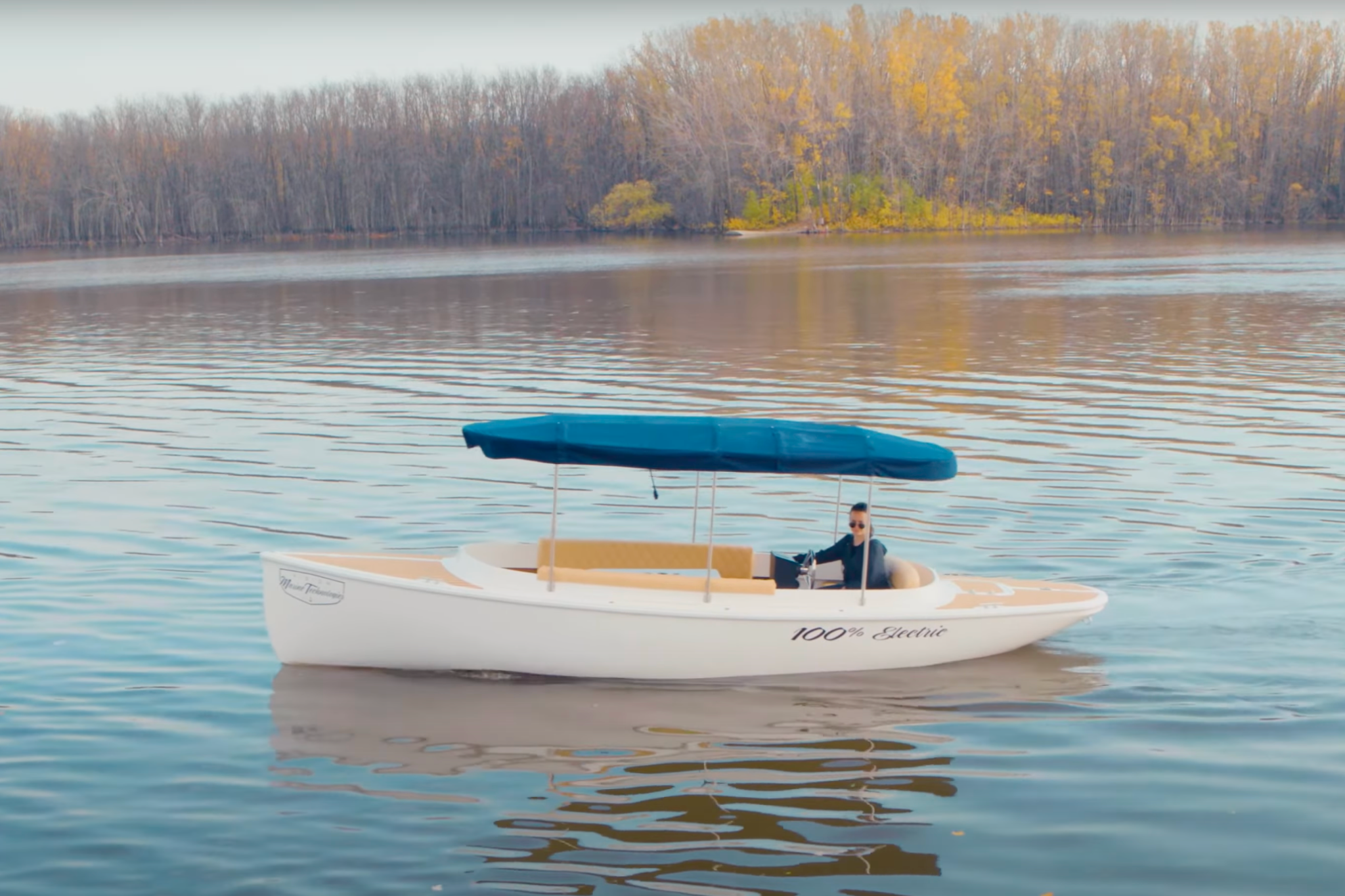 The Fantail 217 cruising on calm inland water, highlighting its compact size, open layout, and electric-powered design as part of its key specifications.