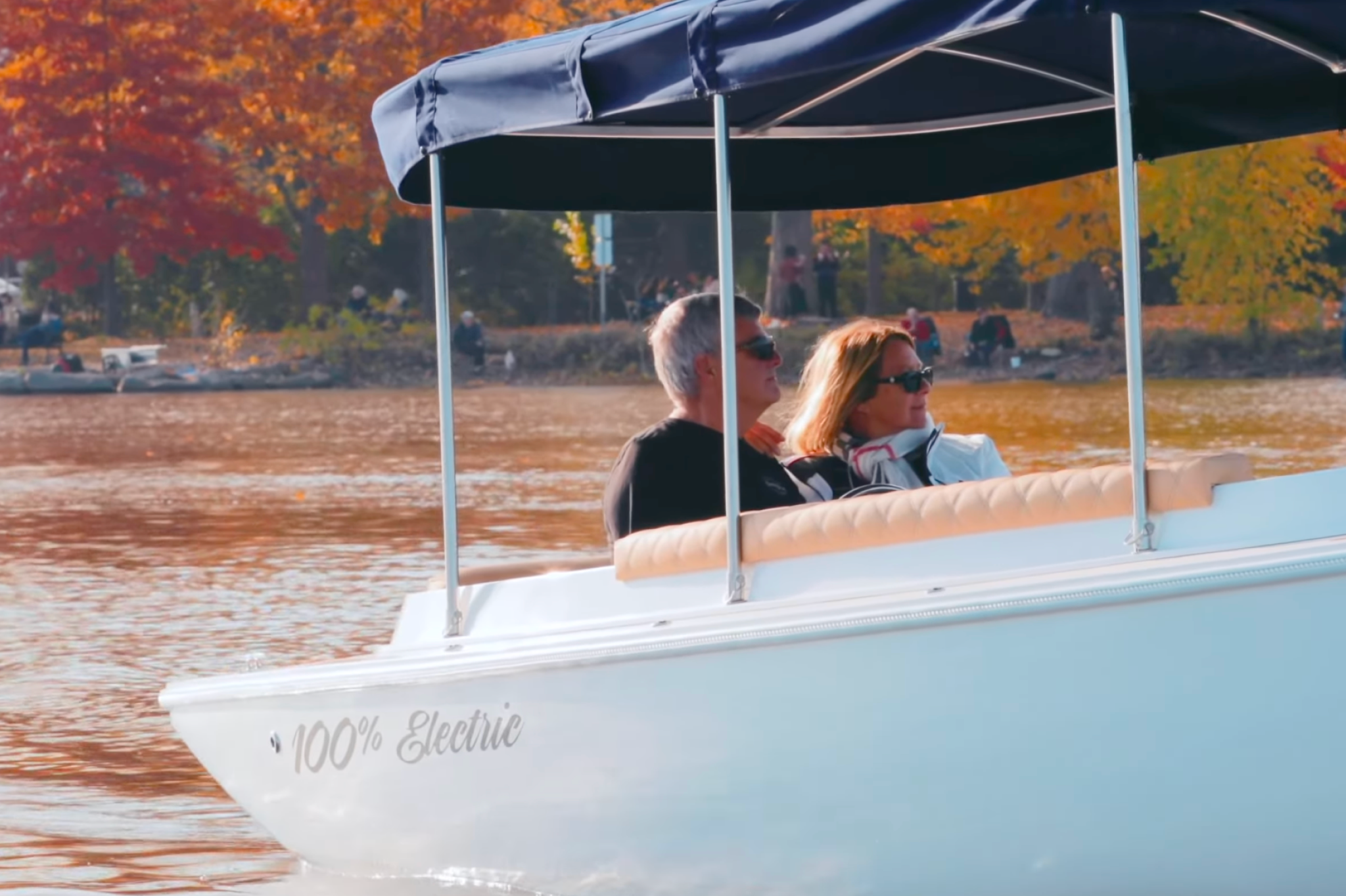 Passengers enjoying a relaxed ride aboard the Fantail 217, showing cushioned seating, shade canopy, and the boat’s comfortable social cruising layout.