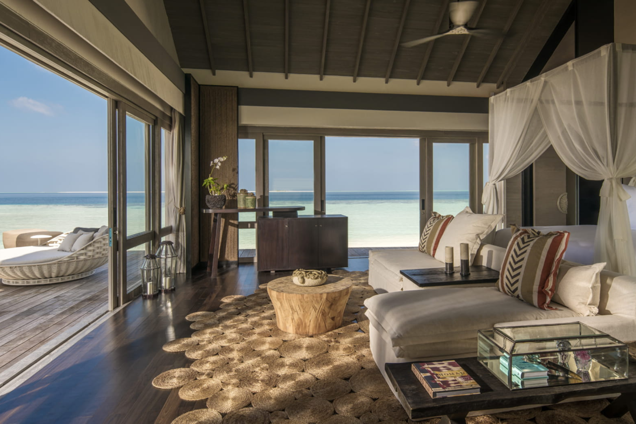 Modern villa interior with panoramic ocean views and private terrace at Voavah, designed in natural tones and textures.