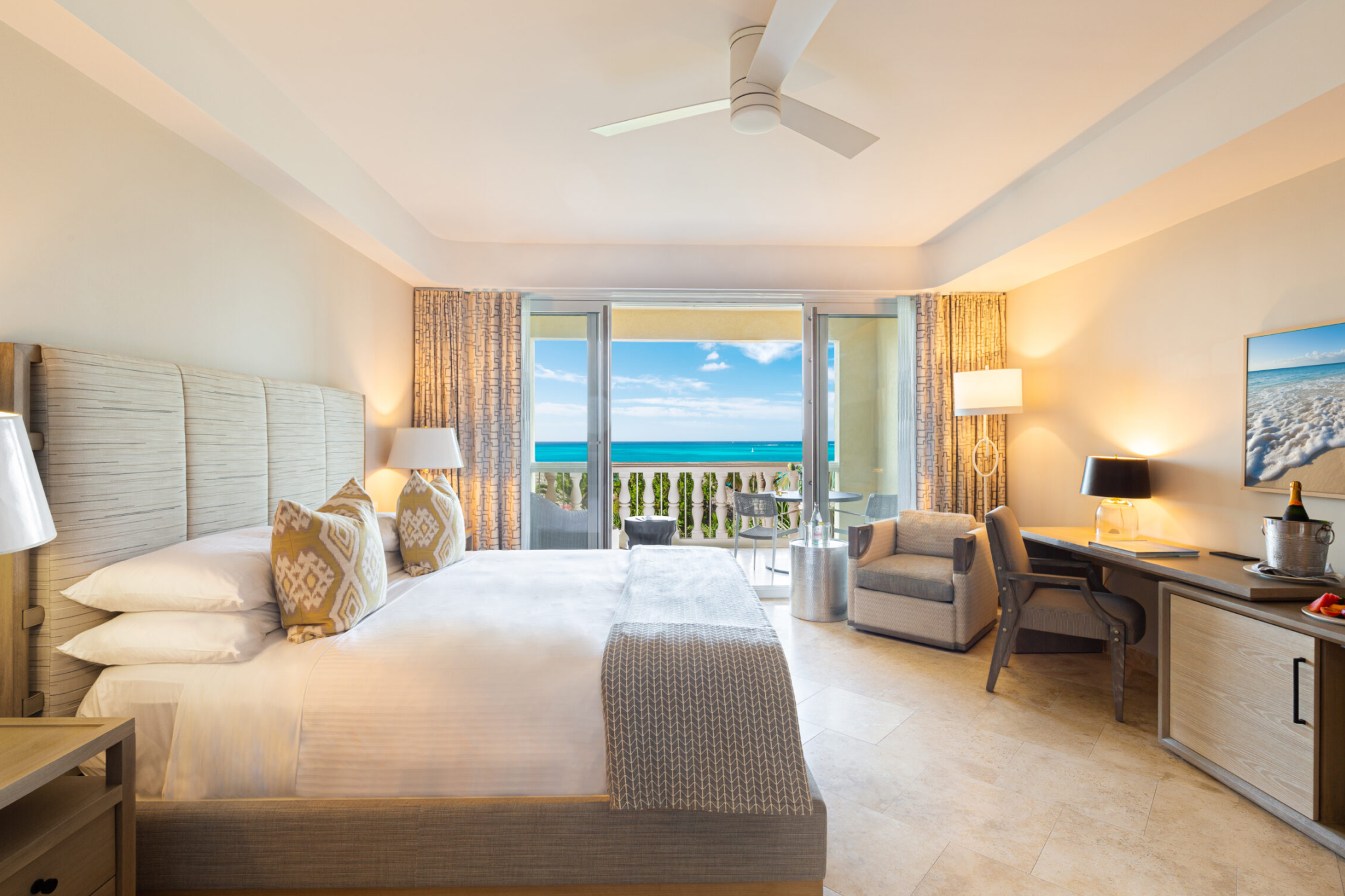 Grace Bay Club oceanfront suite with king bed, private balcony, and sea views.