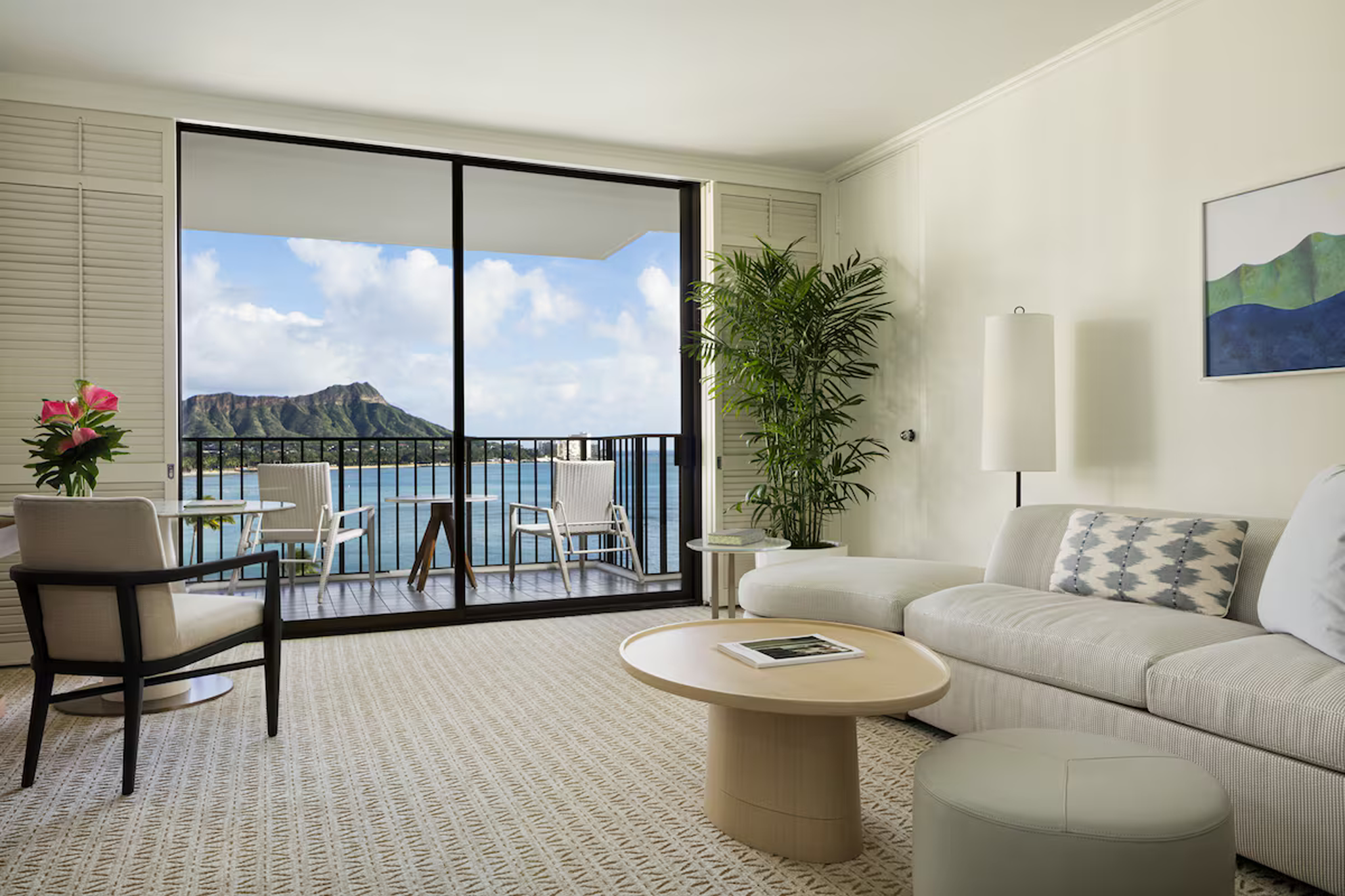 Spacious suite at Halekulani Hotel with panoramic views of Diamond Head and the Pacific Ocean, featuring serene, coastal-inspired interiors.
