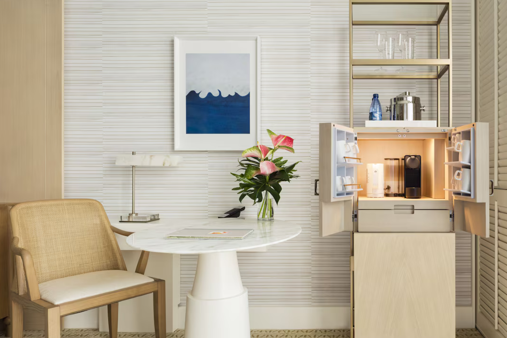 Elegant in-room amenities at Halekulani Hotel, including a built-in mini bar and seating area with modern coastal décor.
