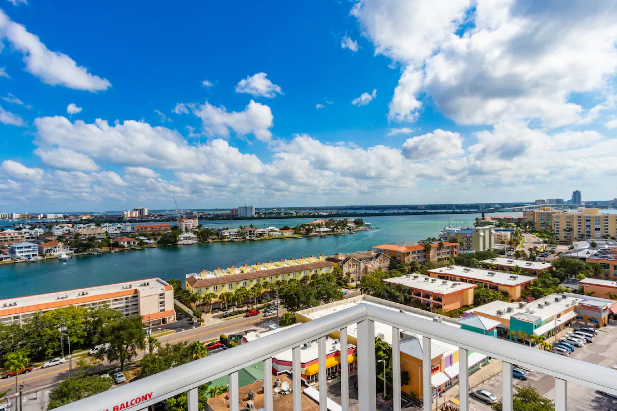 Balcony view from Hampton Inn & Suites Clearwater Beach showing the Intracoastal Waterway and colorful local buildings, a top-ranked stay among the best beach hotels in Clearwater Florida for midrange beachfront access and free breakfast.