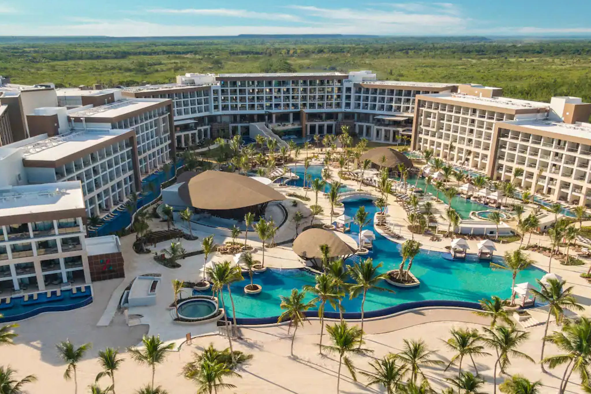 Aerial view of Hyatt Ziva Cap Cana showcasing its pools, buildings, and beachfront location.
