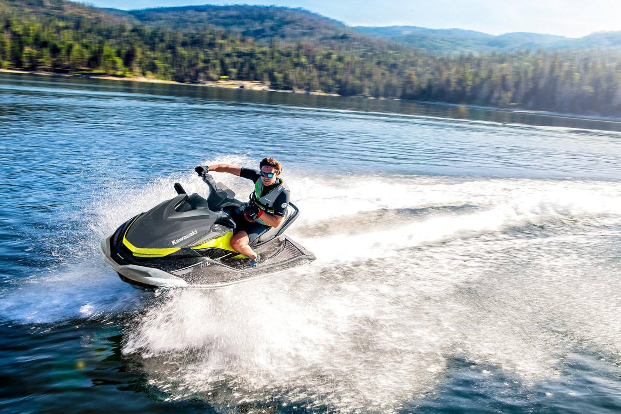 Rider carving across open water on the 2026 Jet Ski ST 160, demonstrating its stable hull, smooth handling, and everyday riding performance.