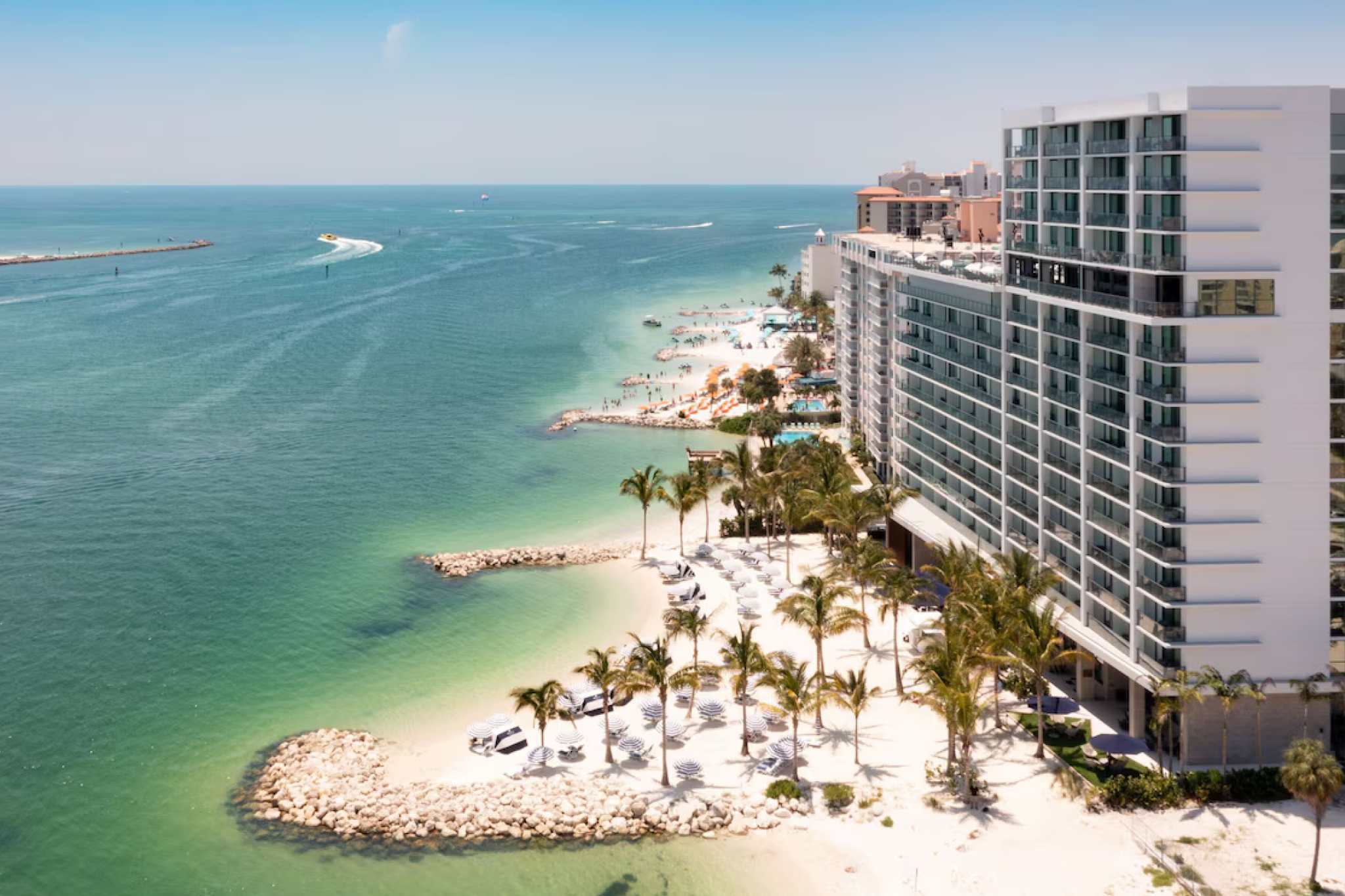 Aerial view of JW Marriott Clearwater Beach Resort & Spa along a pristine shoreline with private beach access, celebrated as the best beach hotel in Clearwater Florida for luxury, wellness, and refined tranquility.