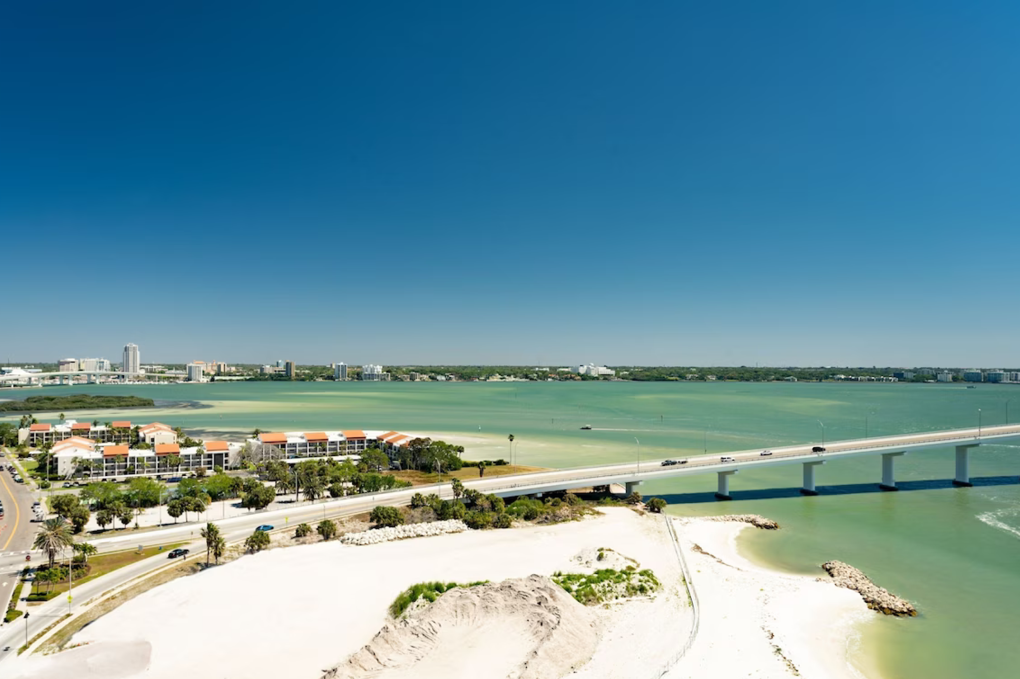 Sweeping view from JW Marriott Clearwater Beach Resort & Spa overlooking the scenic bridge to Sand Key, the turquoise waters of Clearwater Bay, and the peaceful residential coastline beyond.