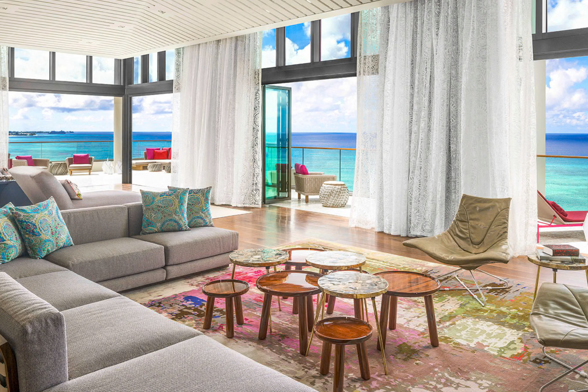 Luxury guest room at Kimpton Seafire Resort + Spa with floor-to-ceiling windows, ocean views, and a private balcony.