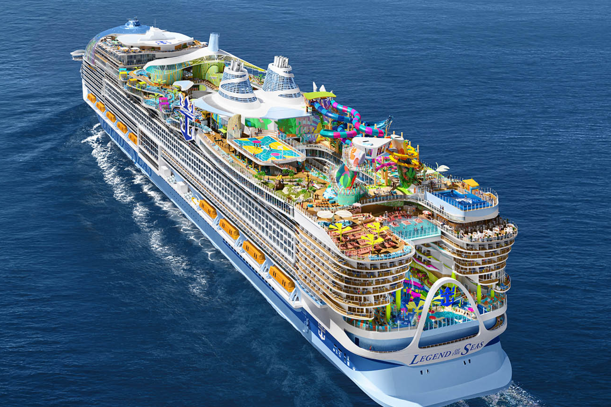 Aerial view of Legend of the Seas sailing through the open ocean, showcasing its expansive upper decks filled with waterparks and activity zones
