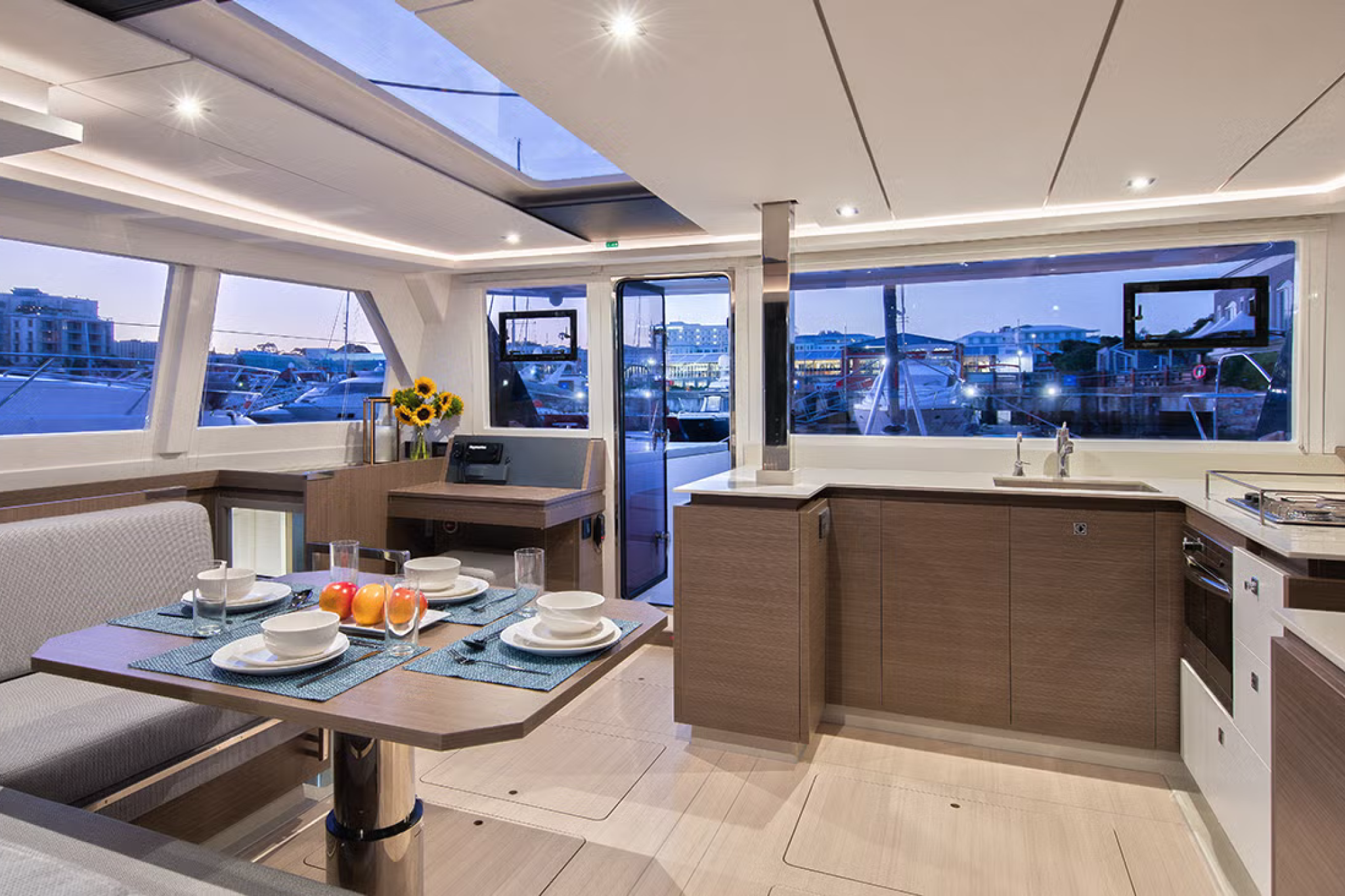 Interior of the Leopard 42 catamaran featuring a bright saloon, modern galley, and panoramic windows.