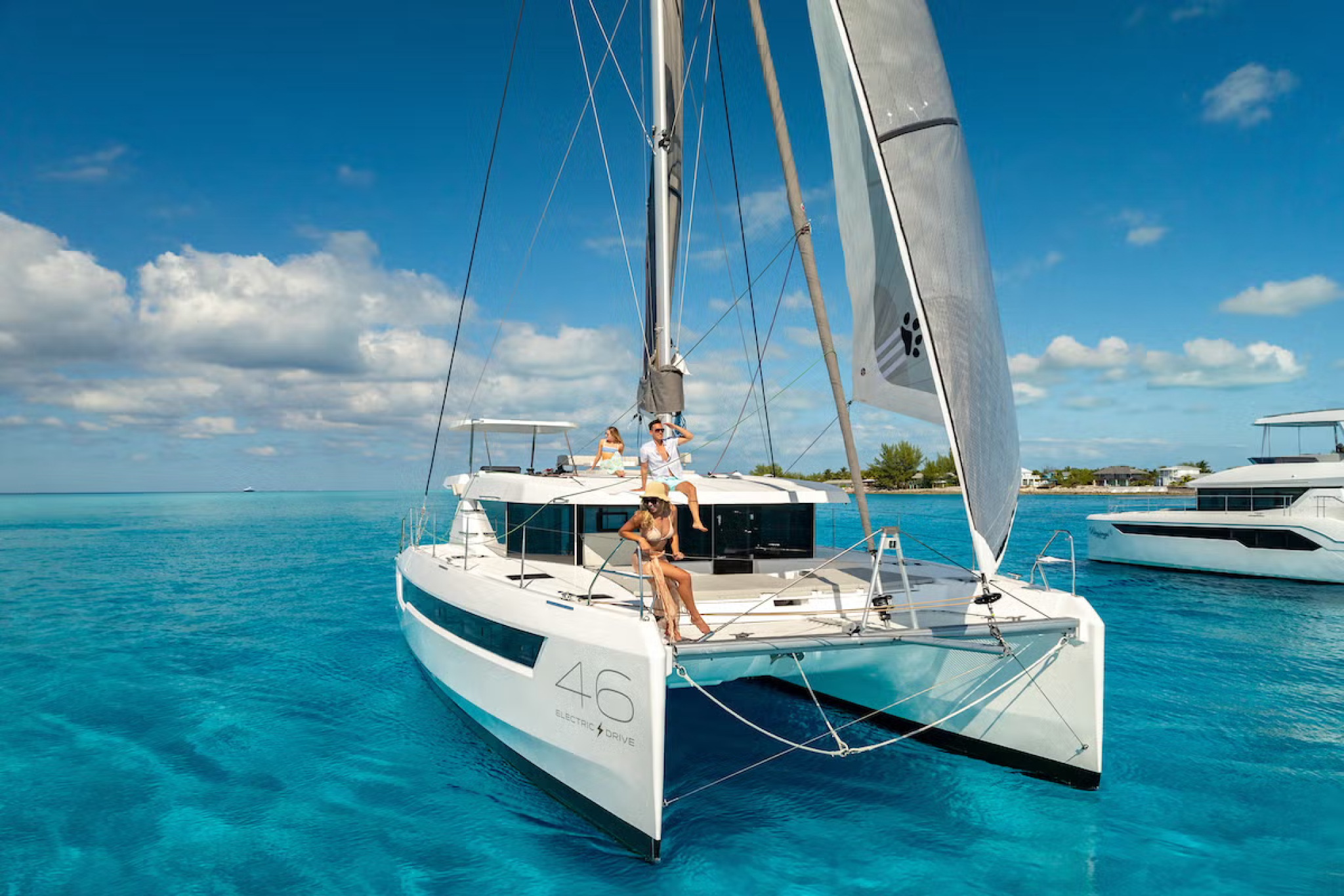 Interior of the Leopard 46 catamaran showing the saloon and galley with large windows, a full dining setup, and modern finishes designed for comfort