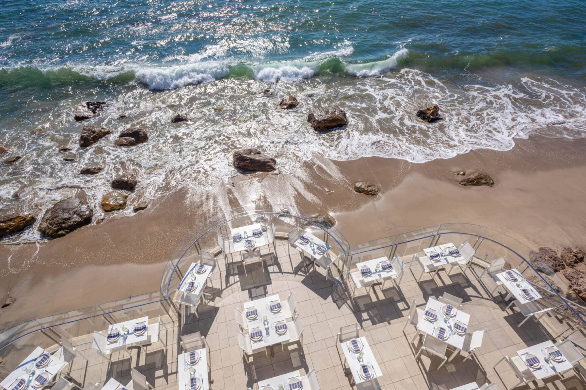 Seaside dining terrace at Malibu Beach Inn overlooking Carbon Beach
