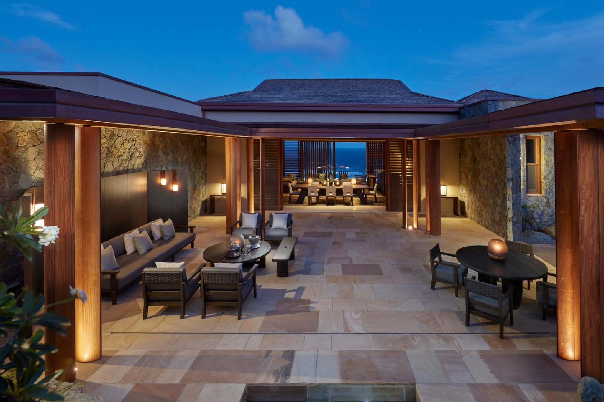 Mandarin Oriental Canouan’s central pavilion blending colonial-style white columns with modern coastal elegance, framed by tropical landscaping.