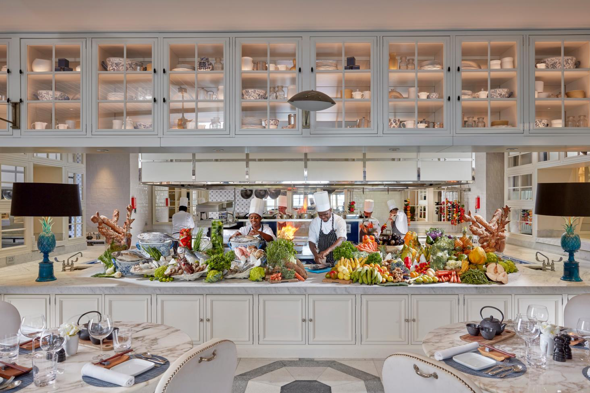 Plated gourmet seafood dish at Mandarin Oriental Canouan’s TIDES restaurant, showcasing fine dining with Caribbean and international influences.