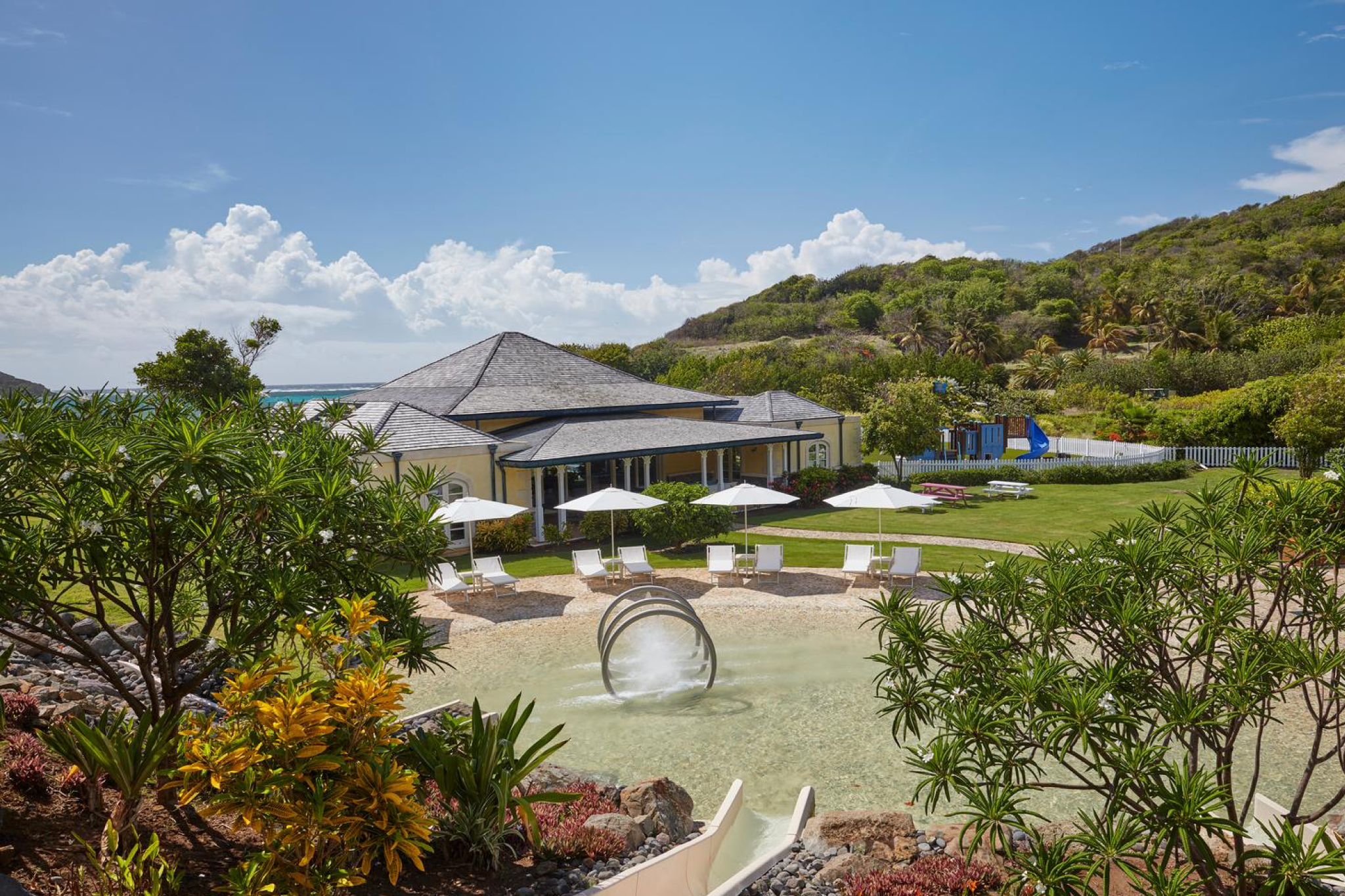 Personal butler service setting up an in-villa breakfast with ocean views—an example of Mandarin Oriental Canouan’s discreet service style.
