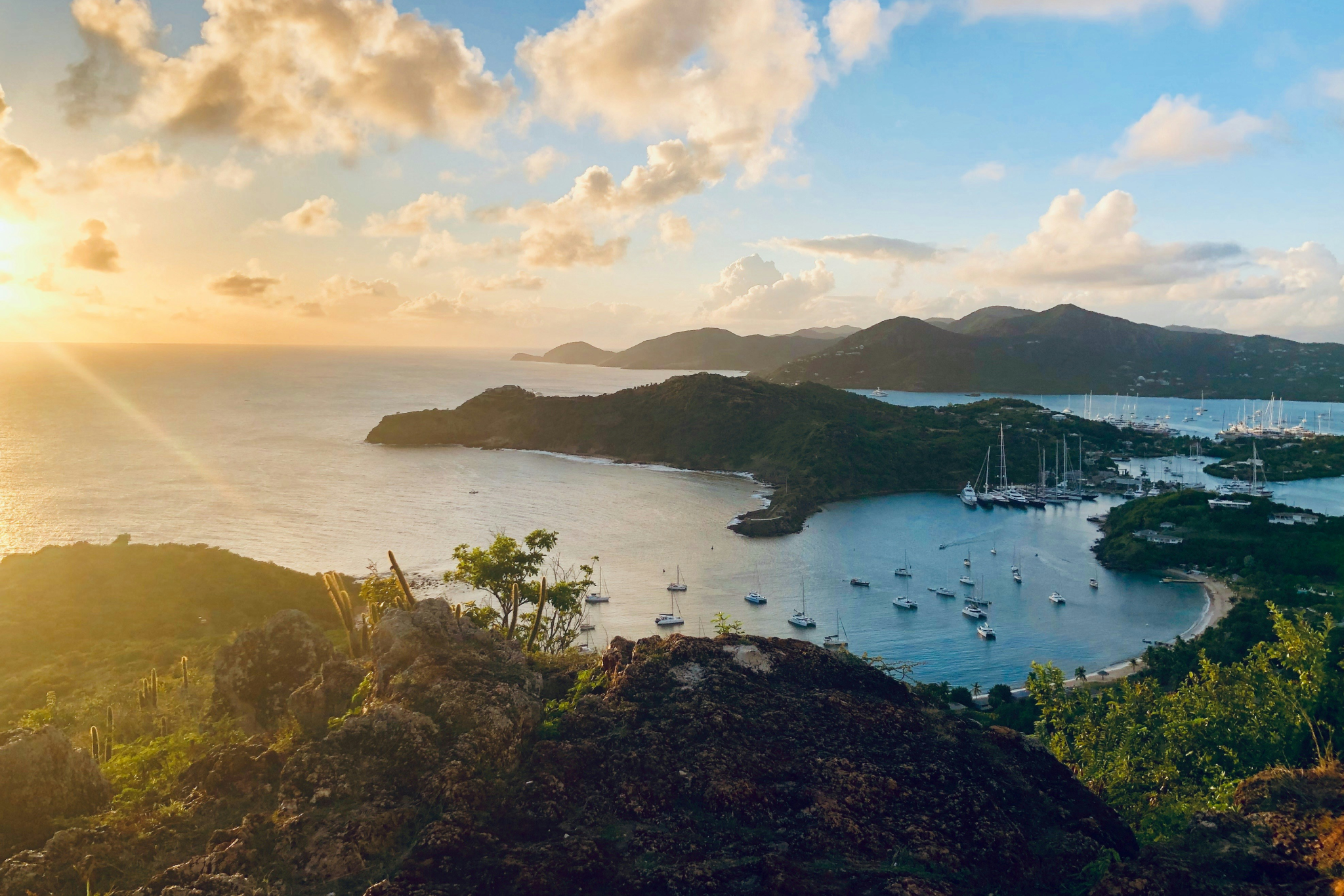 Golden sunset over English Harbour in Antigua with sailing boats in protected bay, one of the most scenic Caribbean islands