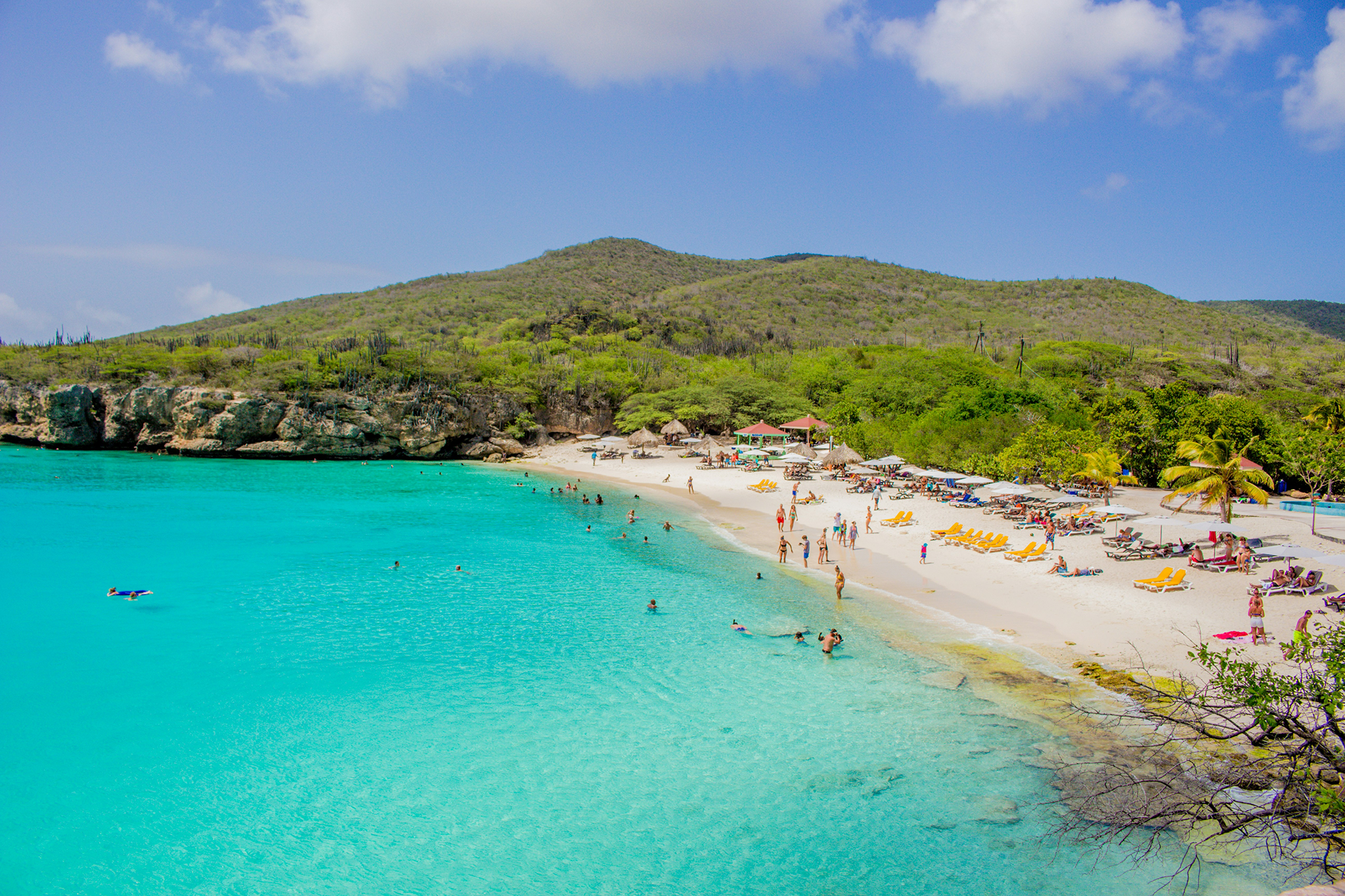 Stunning turquoise bay in Curaçao with white sand beach and green hills, one of the most scenic Caribbean islands