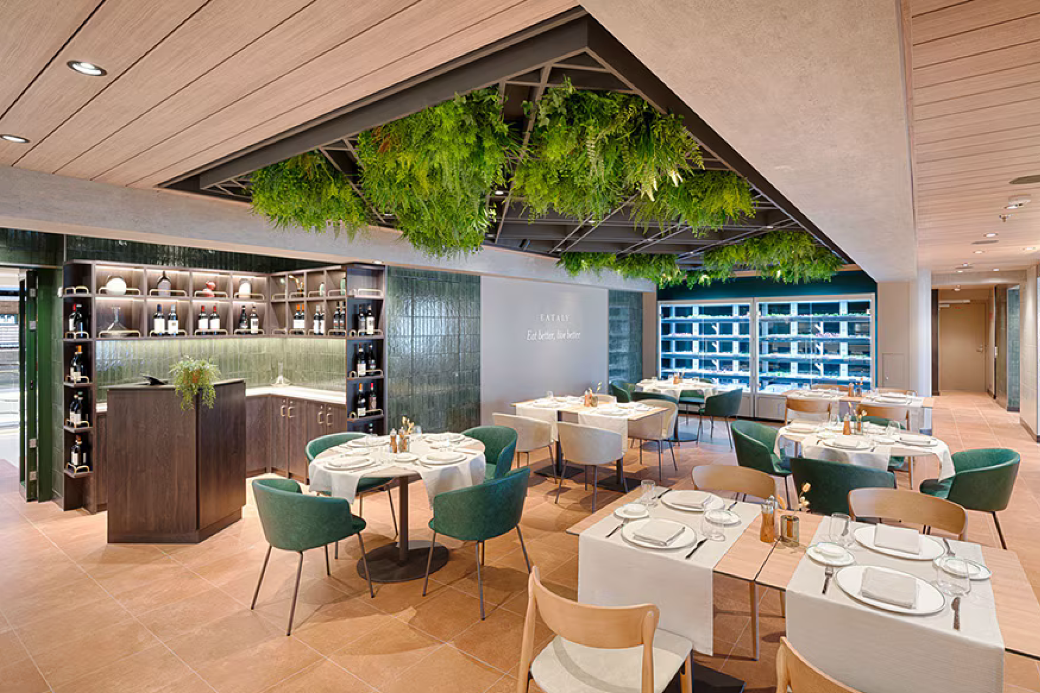 Eataly restaurant on MSC World America offering refined dining in a botanical-inspired setting with wine display walls.