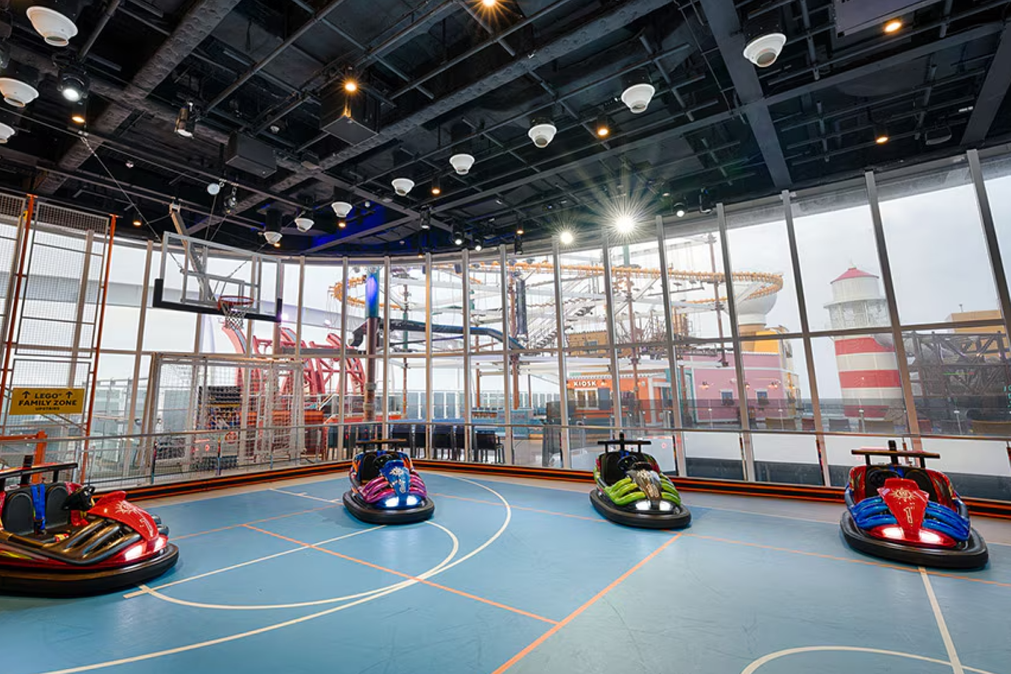 Family fun zone on MSC World America featuring a multipurpose indoor sports court and bumper cars with ocean views.