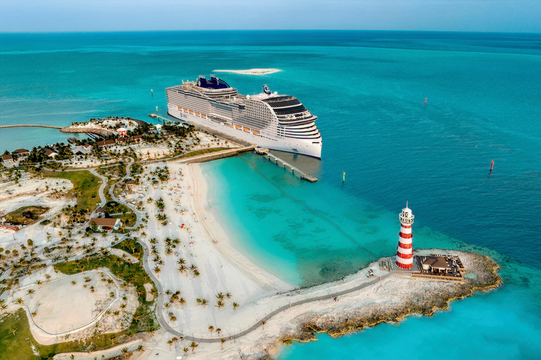 MSC World America docked at Ocean Cay MSC Marine Reserve, surrounded by turquoise waters and palm-lined beaches.