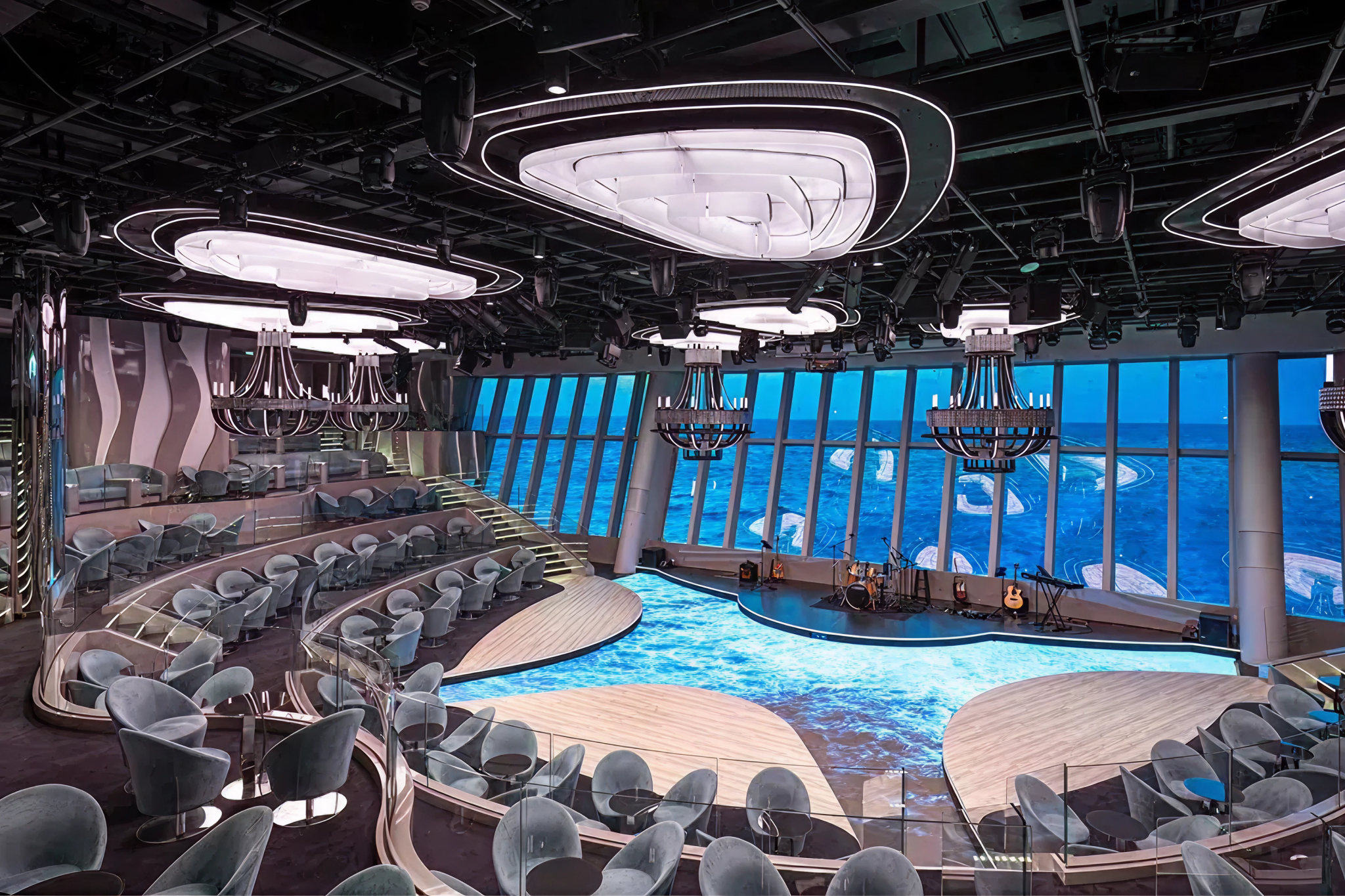Multi-story theater onboard MSC World Asia showcasing immersive live performances, modern lighting, and panoramic sea views