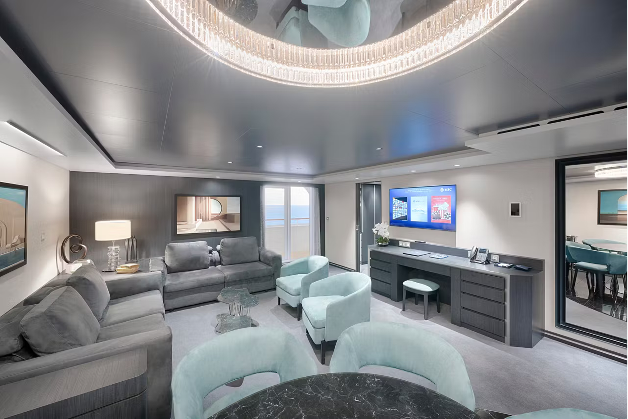 MSC World Asia Yacht Club suite interior with contemporary living space, ocean-view balcony, and luxury furnishings