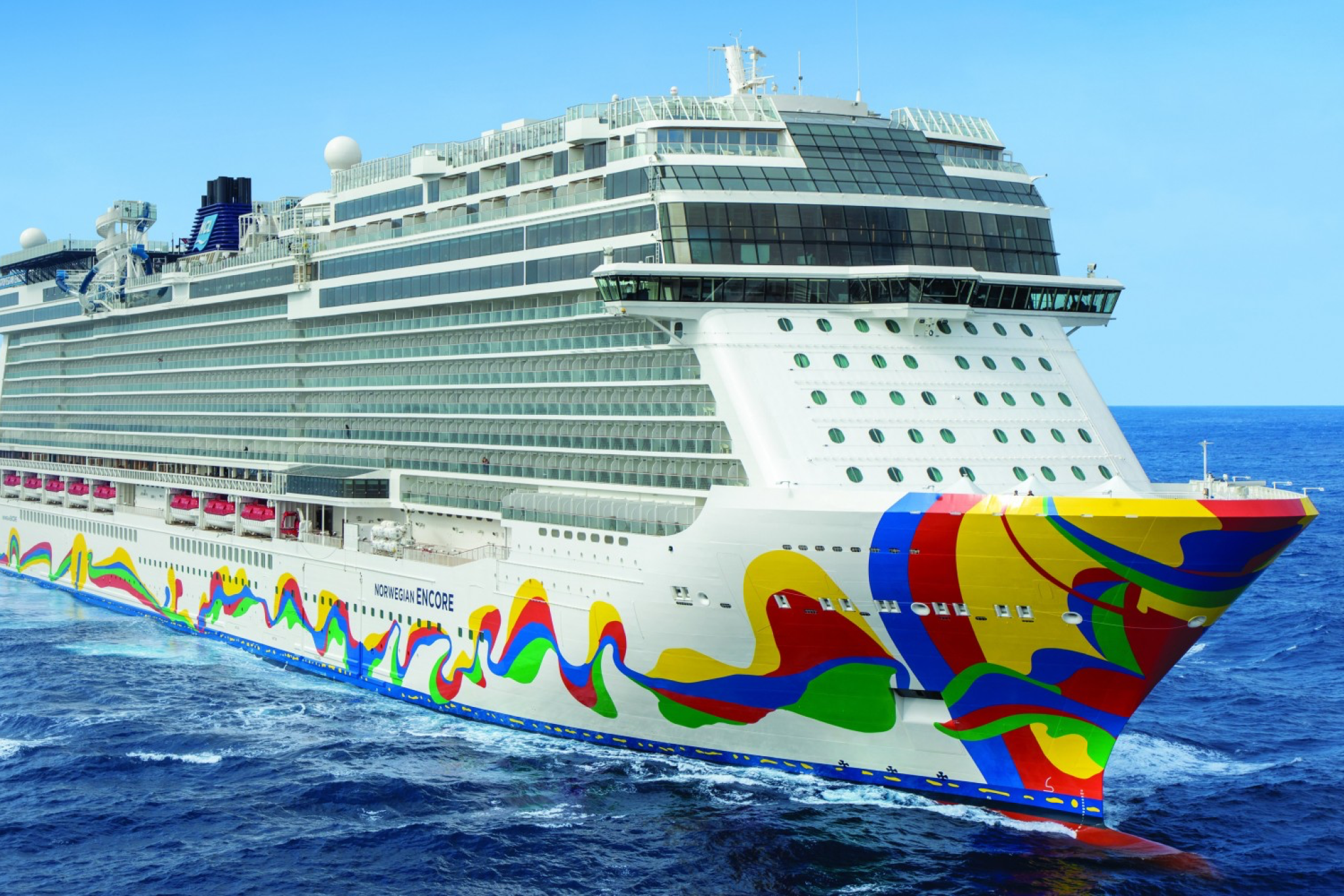 Norwegian Encore cruise ship sailing at sea, showcasing its vibrant hull artwork and modern multi-deck design.