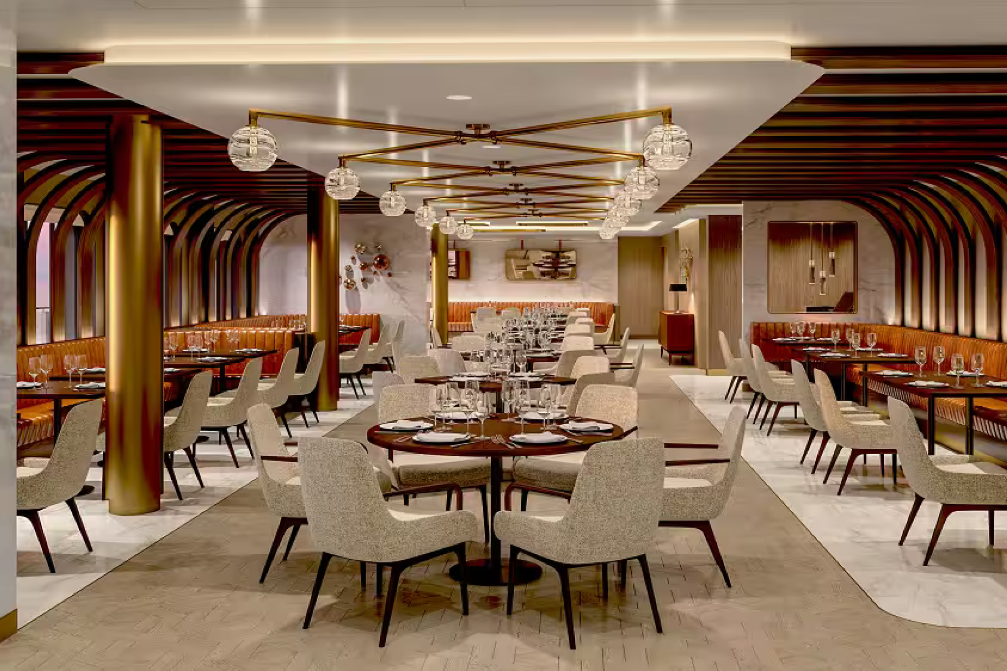 Elegant dining venue on Norwegian Encore with modern lighting, gold accents, and stylish seating for specialty dining.