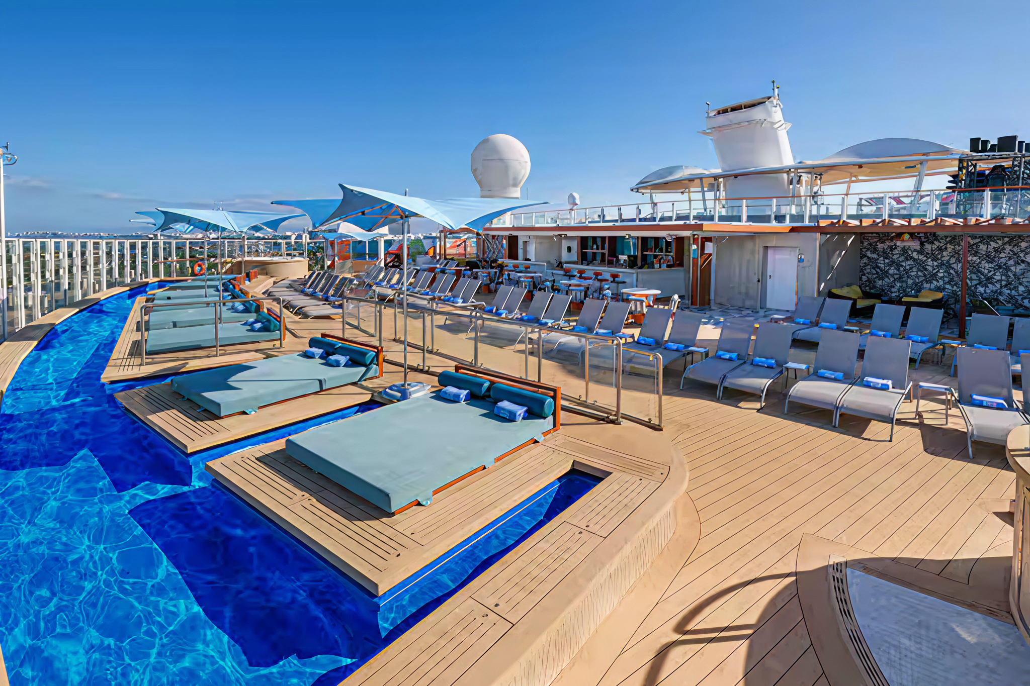 Private sun deck on Norwegian Encore featuring loungers, a plunge pool, and panoramic ocean views for Haven guests.