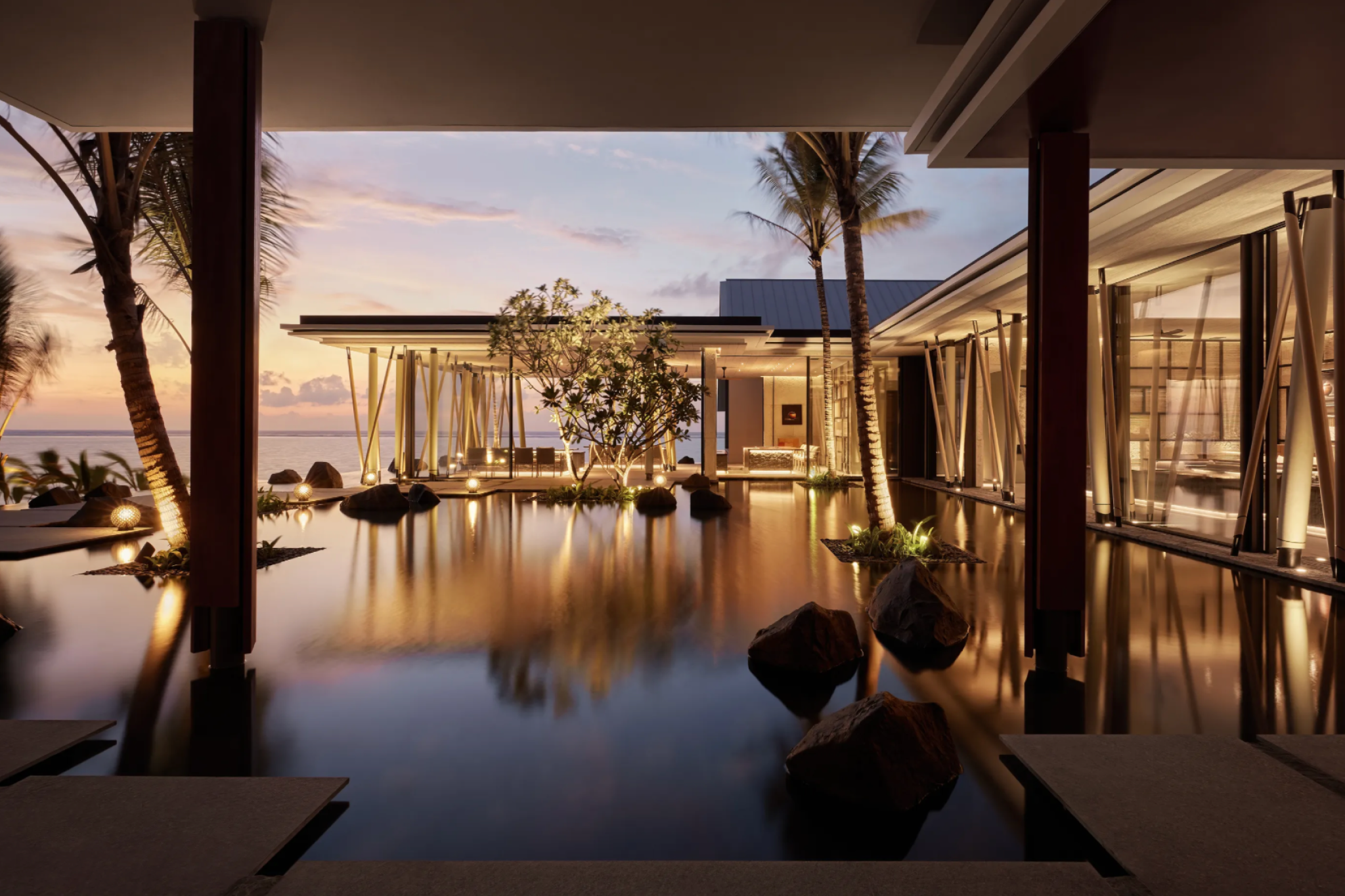 Entrance of One&Only Reethi Rah featuring contemporary island architecture with water features and ocean-facing design.