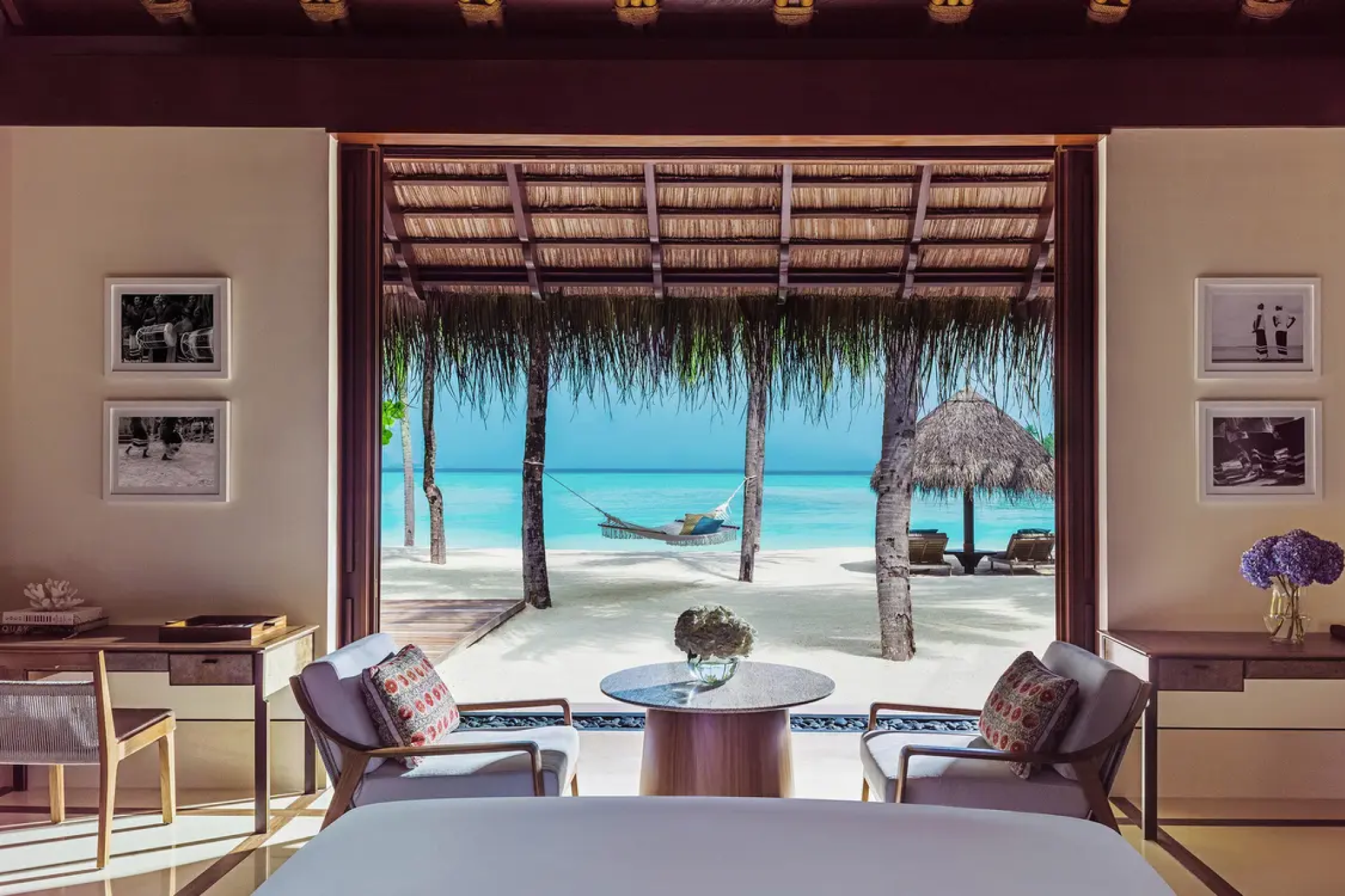 Beachfront villa at One&Only Reethi Rah with hammock, loungers, and direct access to white sand and crystal-clear water.