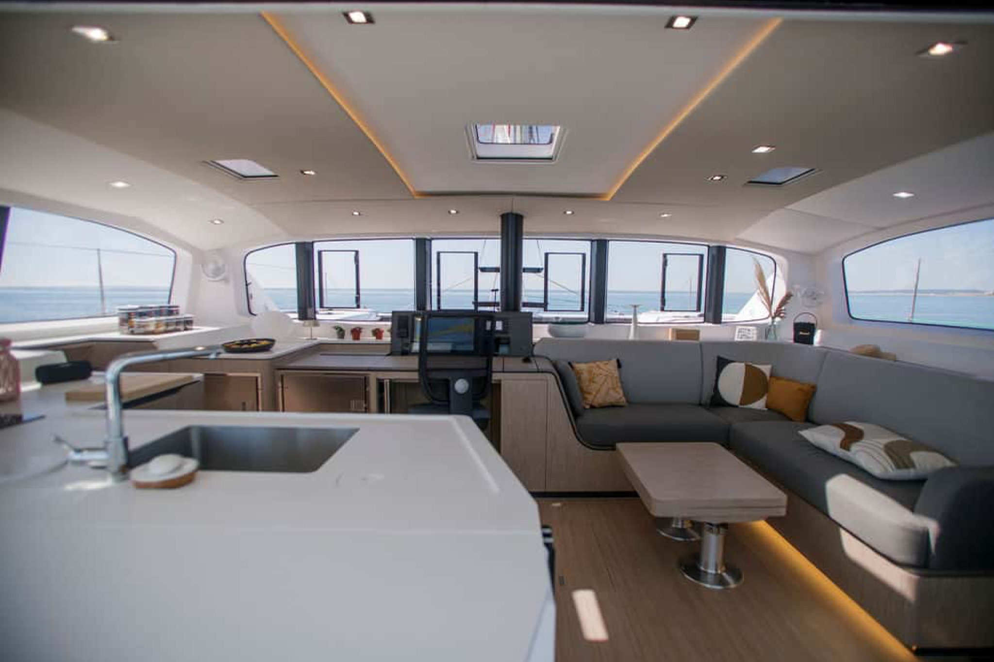 Interior of the Outremer 52 featuring the saloon with galley, navigation station, and seating area.
