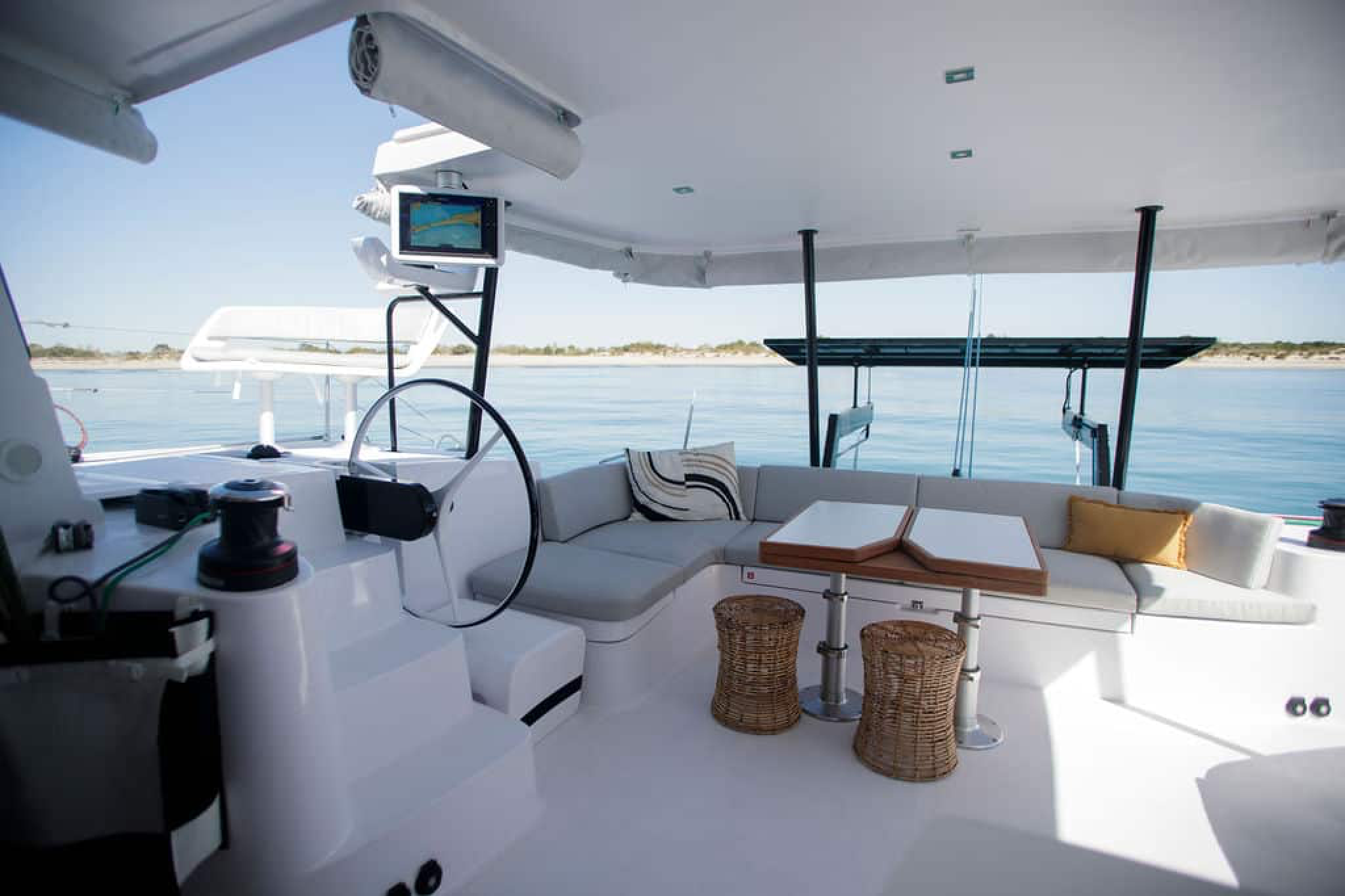Cockpit of the Outremer 52 with dining table, cushioned seating, and helm access.