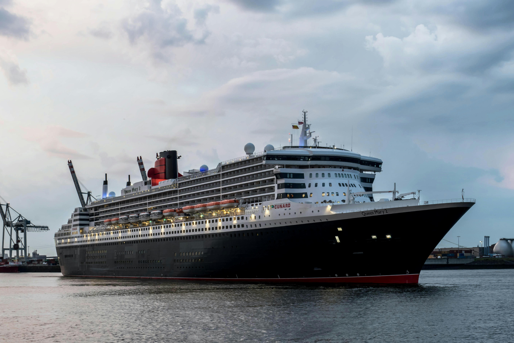 Cunard’s Queen Mary 2 docked in port, the only mainstream ocean liner that offers kennels for dogs and cats on pet-friendly cruises.