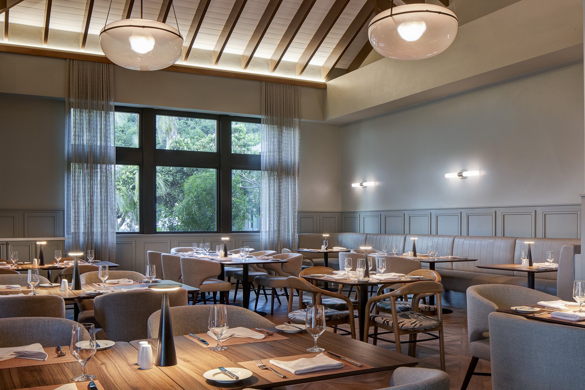 Refined dining room at Peter Island Resort with modern Caribbean decor, showcasing a relaxed and upscale restaurant ambiance.