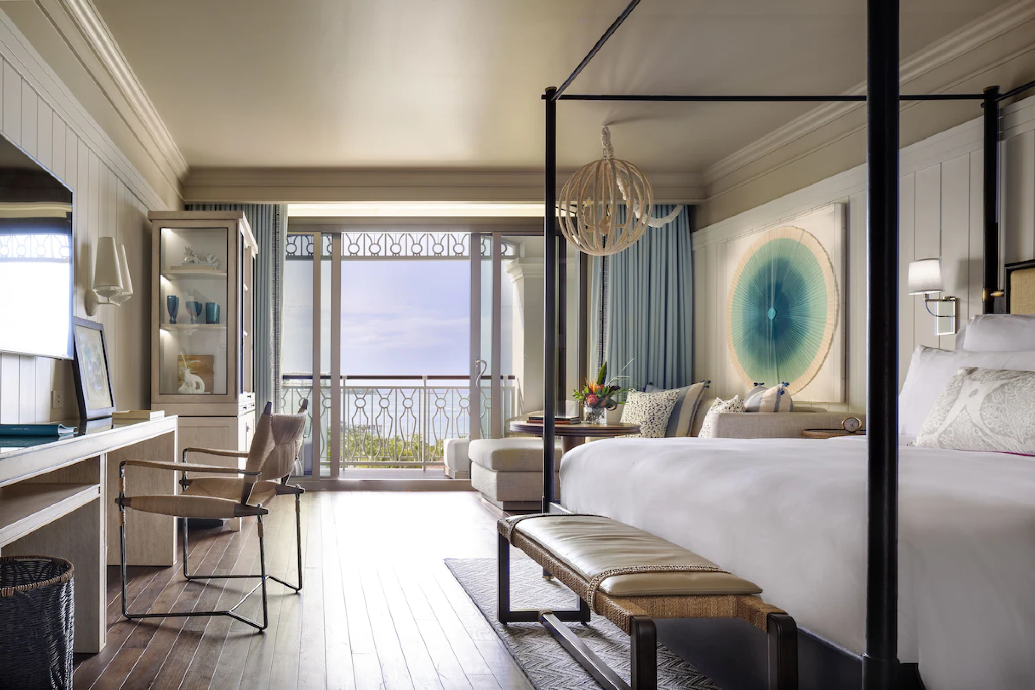 Elegant ocean-facing guest suite with balcony and luxury decor at Rosewood Baha Mar.