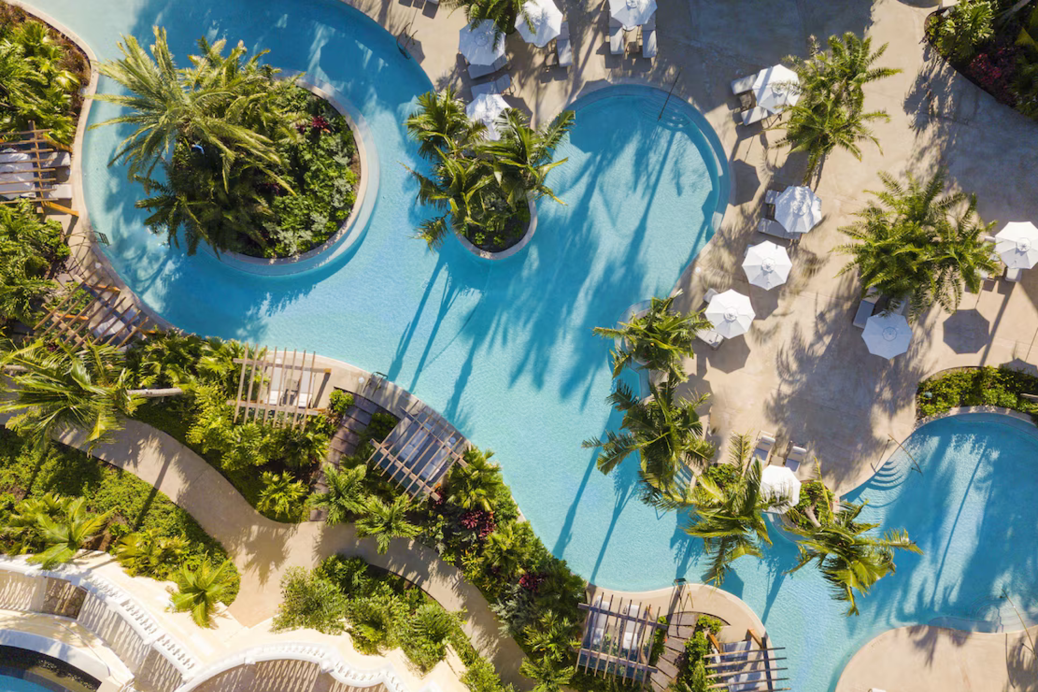 Aerial view of lagoon-style pools and lush gardens at Rosewood Baha Mar.