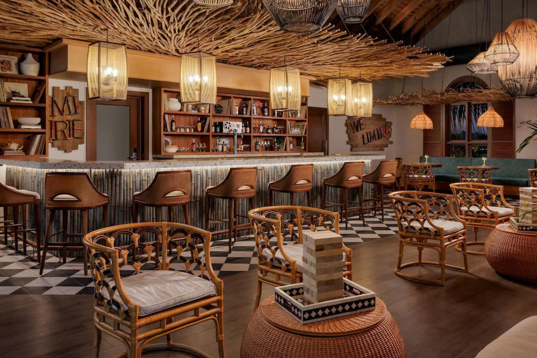 Indoor lounge and cocktail bar at Sandals Saint Vincent featuring natural wood textures, Caribbean-inspired decor, wicker seating, and a relaxed evening ambiance.