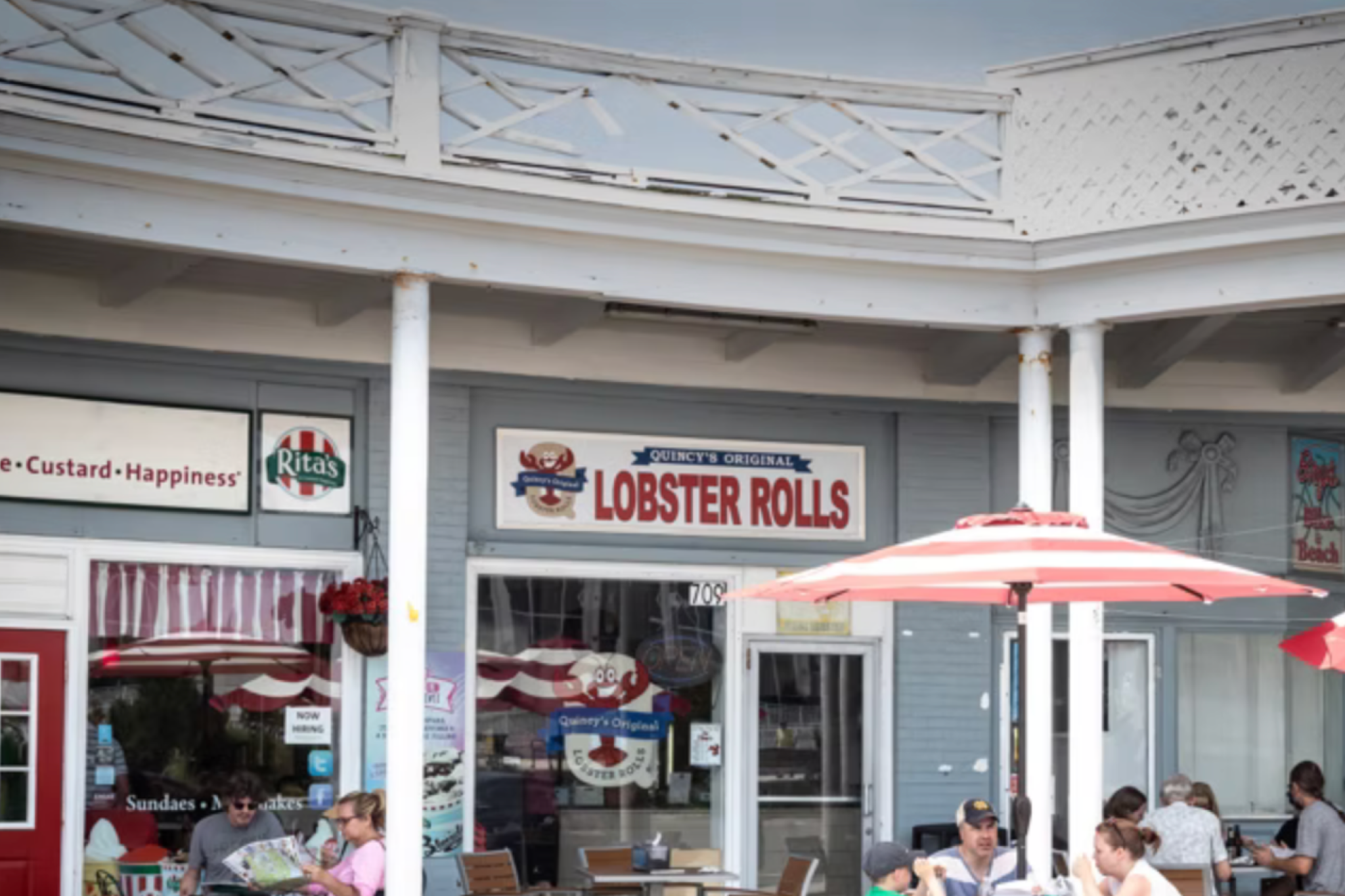 Exterior of Quincy’s Original Lobster Rolls with red signage and outdoor seating, a go-to stop among the Best Seafood Restaurants in Cape May for authentic lobster rolls.