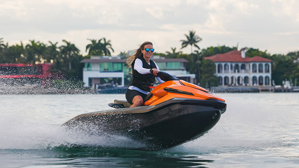 Rider on the Taiga Orca Electric PWC, an eco-friendly watercraft included in the list of the most expensive jet skis in the world.